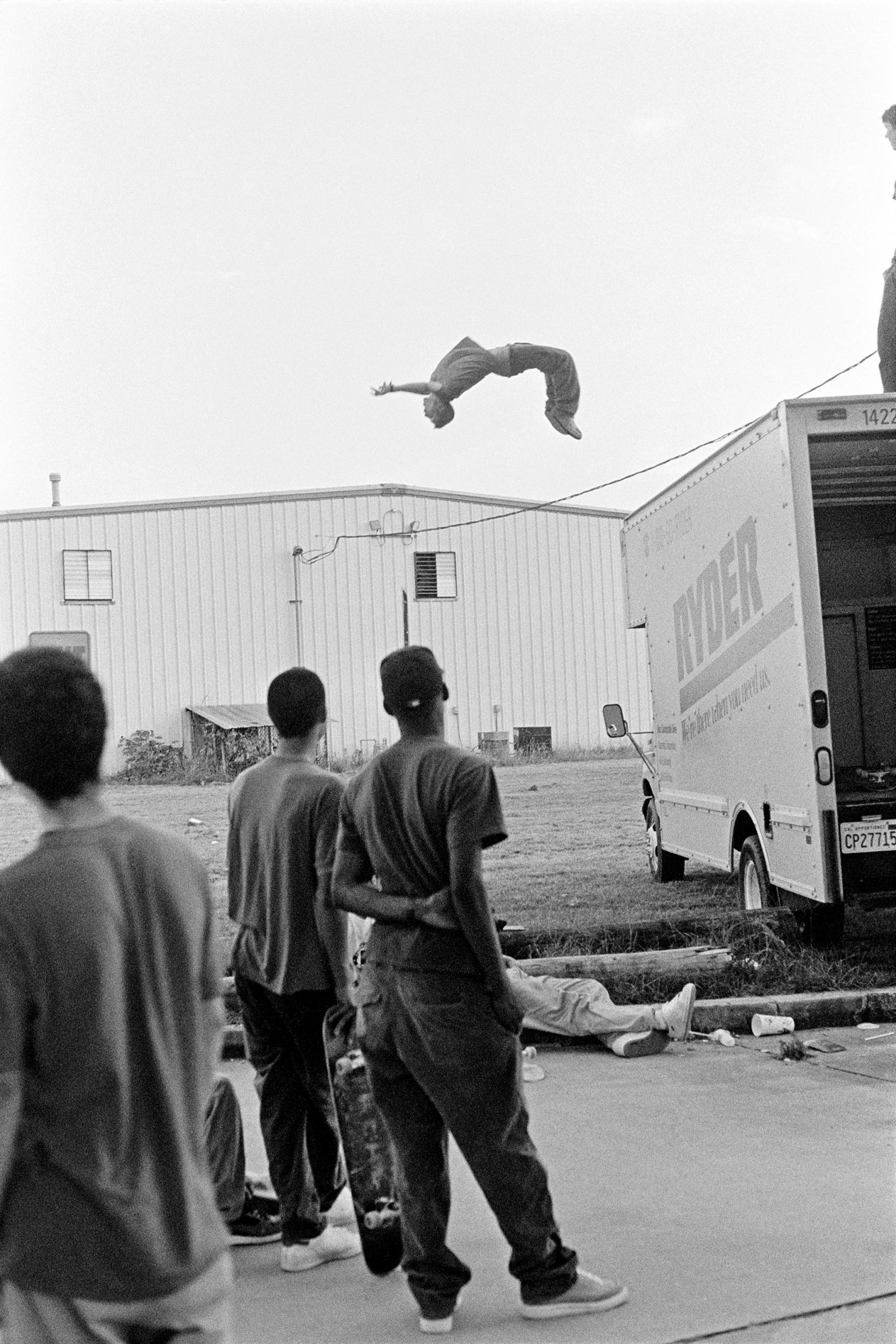 a man backflipping off the back of a van