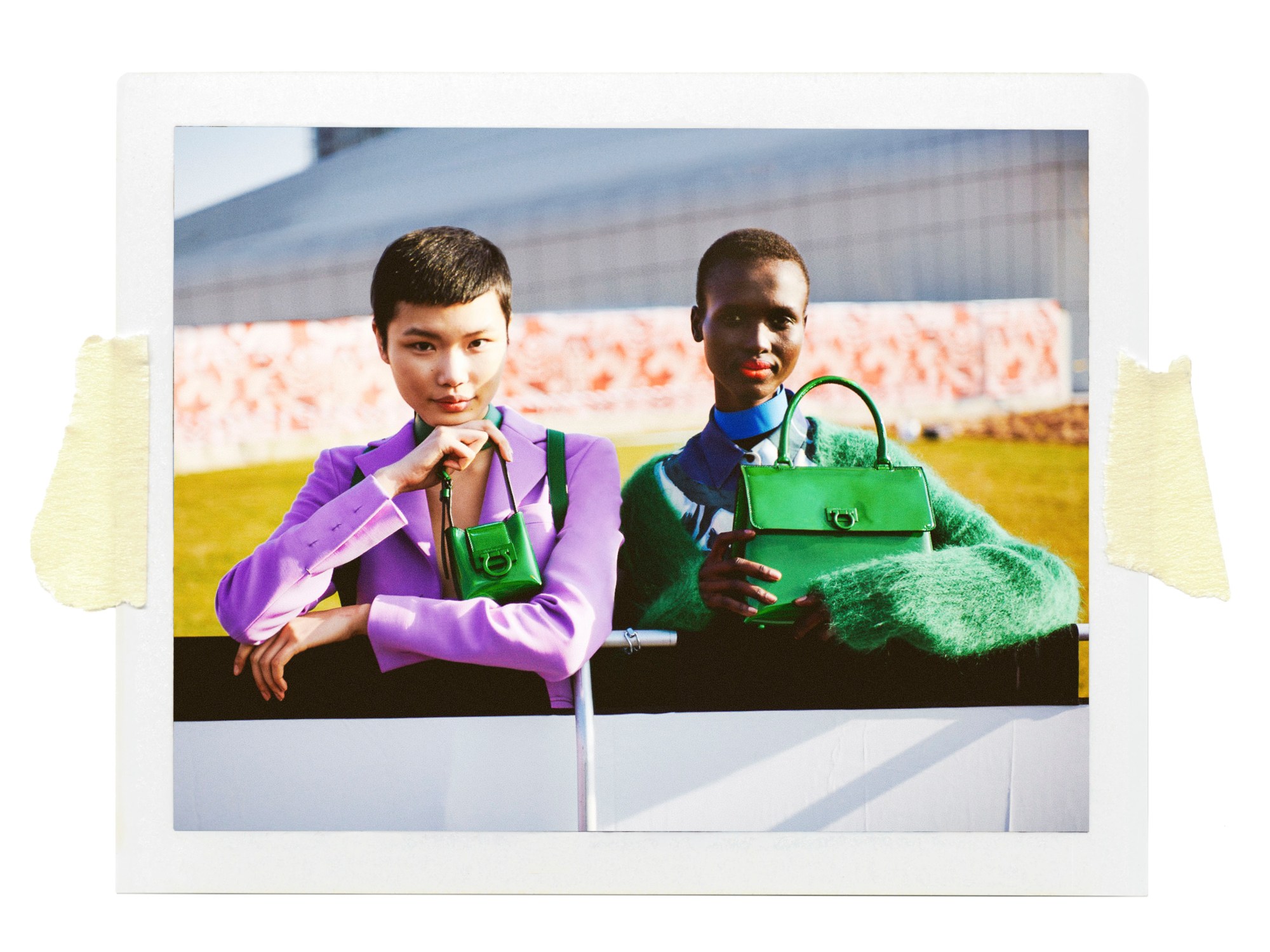 two models holding salvatore ferragamo handbags