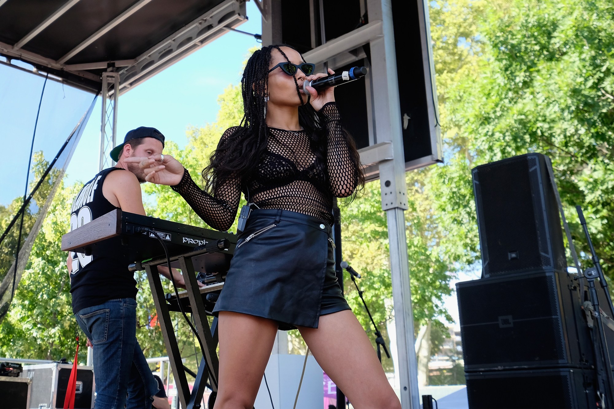 zoe kravitz holding a mic and singing on stage at made in america festival 2015