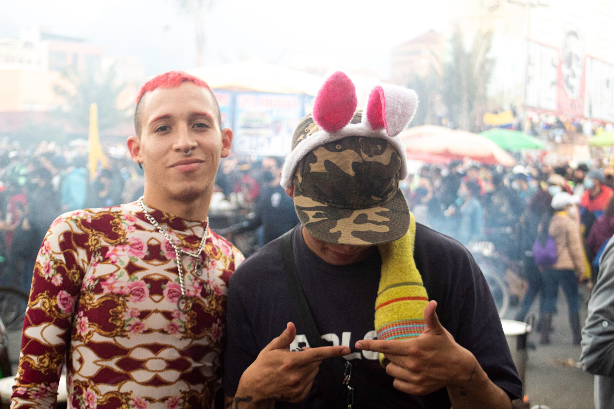 portrait of two queer activists in a crowd in bogota colombia