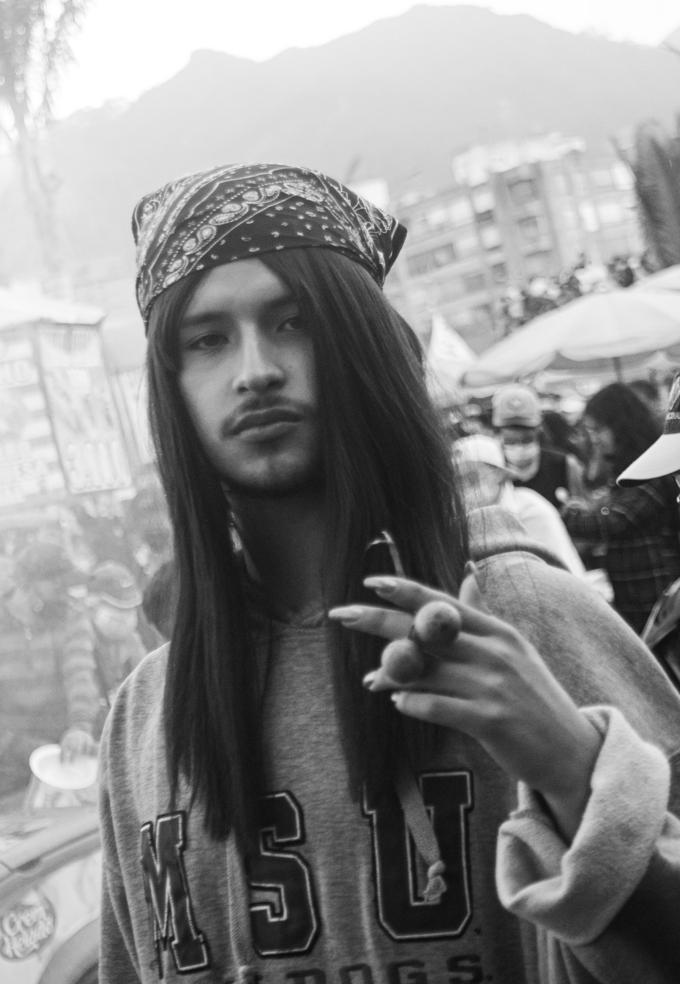 portrait of a queer protester with long hair in bogota colombia