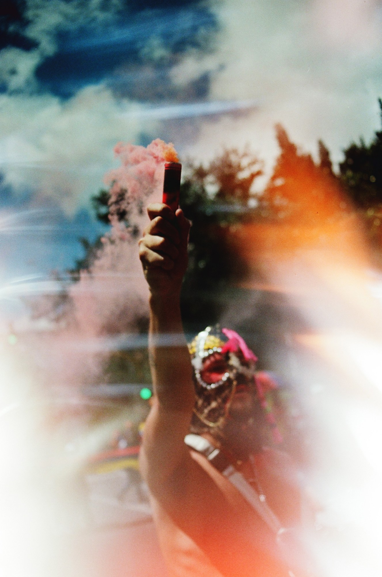 a protester holding up a roman candle in bogota colombia