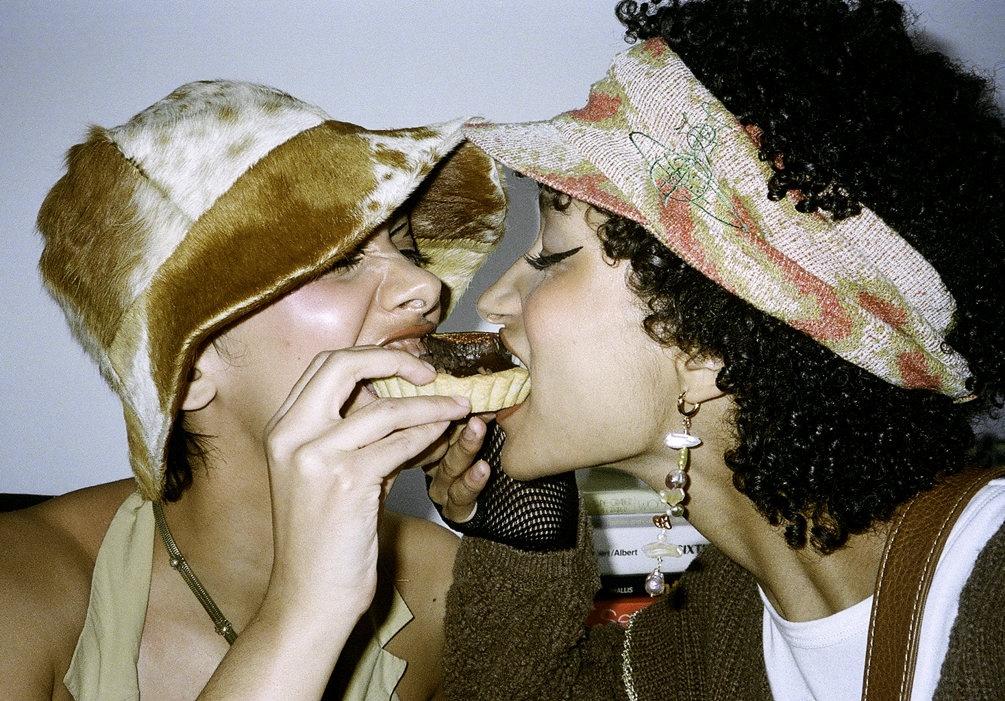 two models eating a pastry in janky jewels