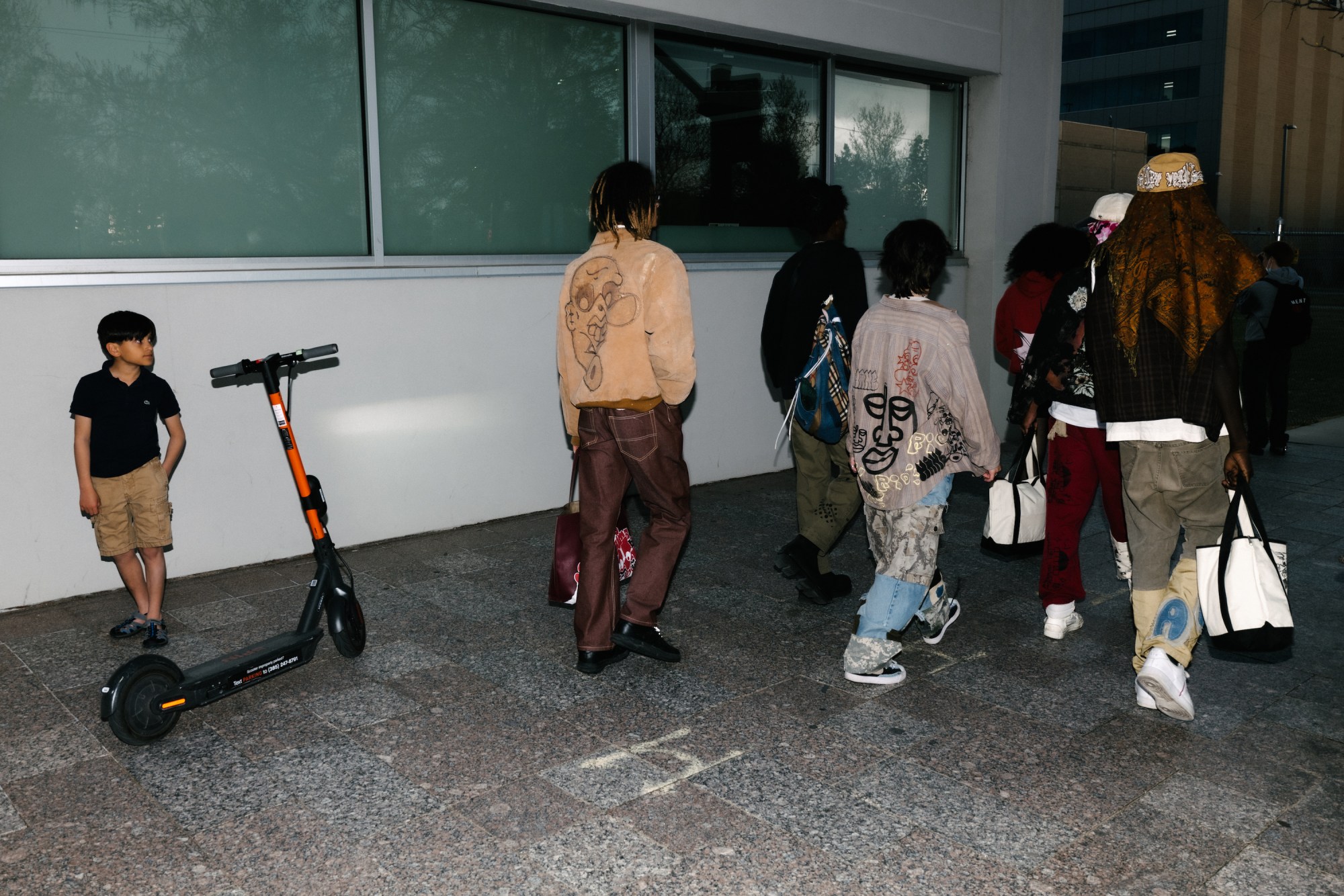 a group of kids in salt lake city walking down the sidewalk in upcycled clothes by blake lewis