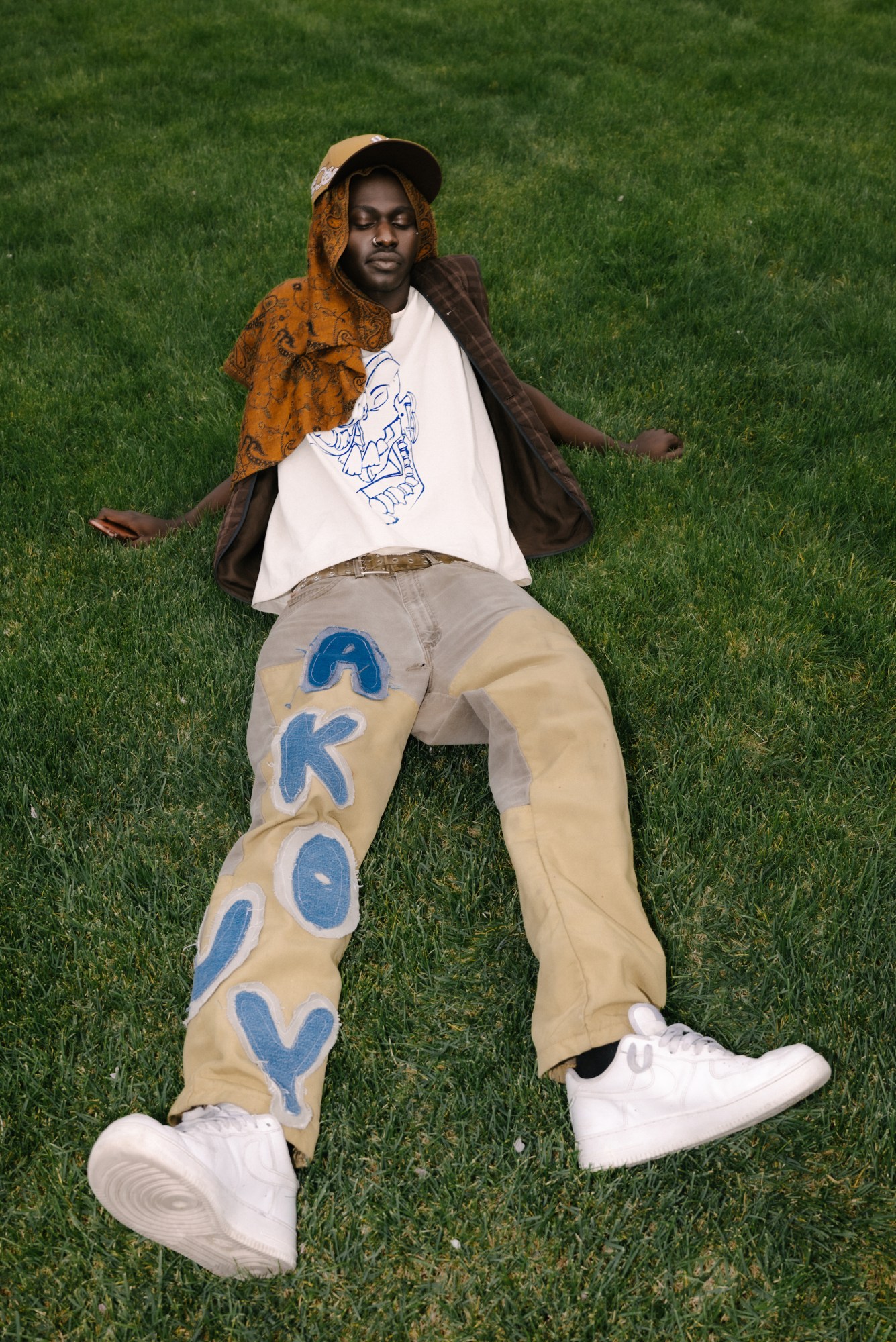 a boy lying in the grass in salt lake city utah by blake lewis