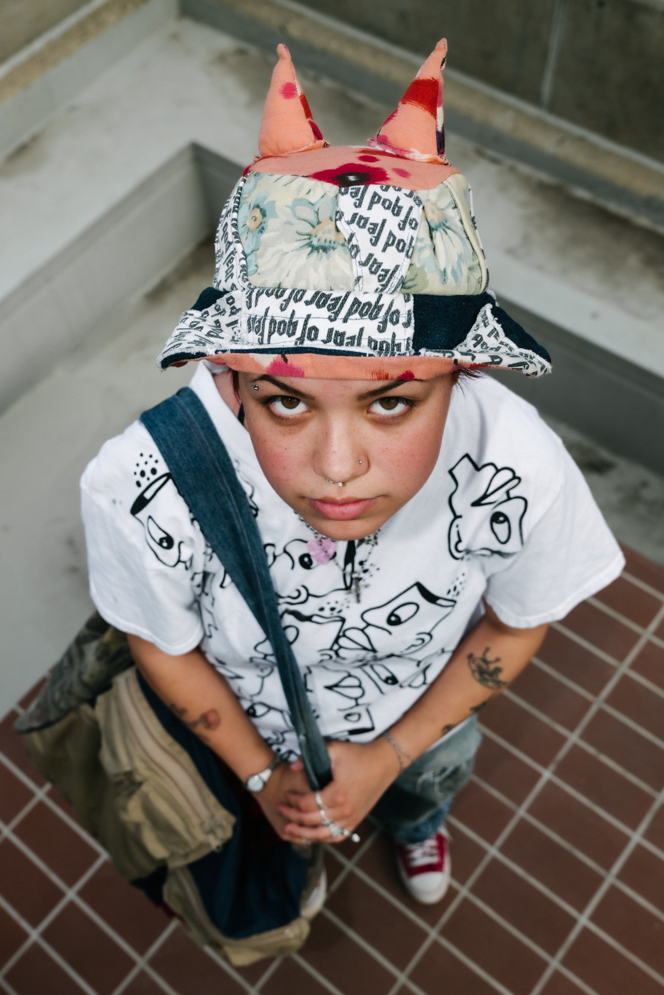 portrait of a girl in a handmade graphic hat with ears by blake lewis