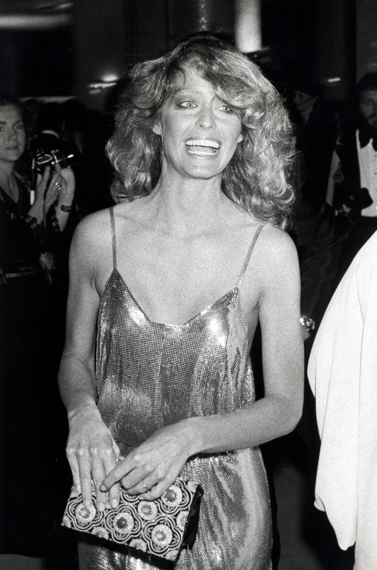 farrah fawcett smiling and clutching her purse at the academy awards 1978