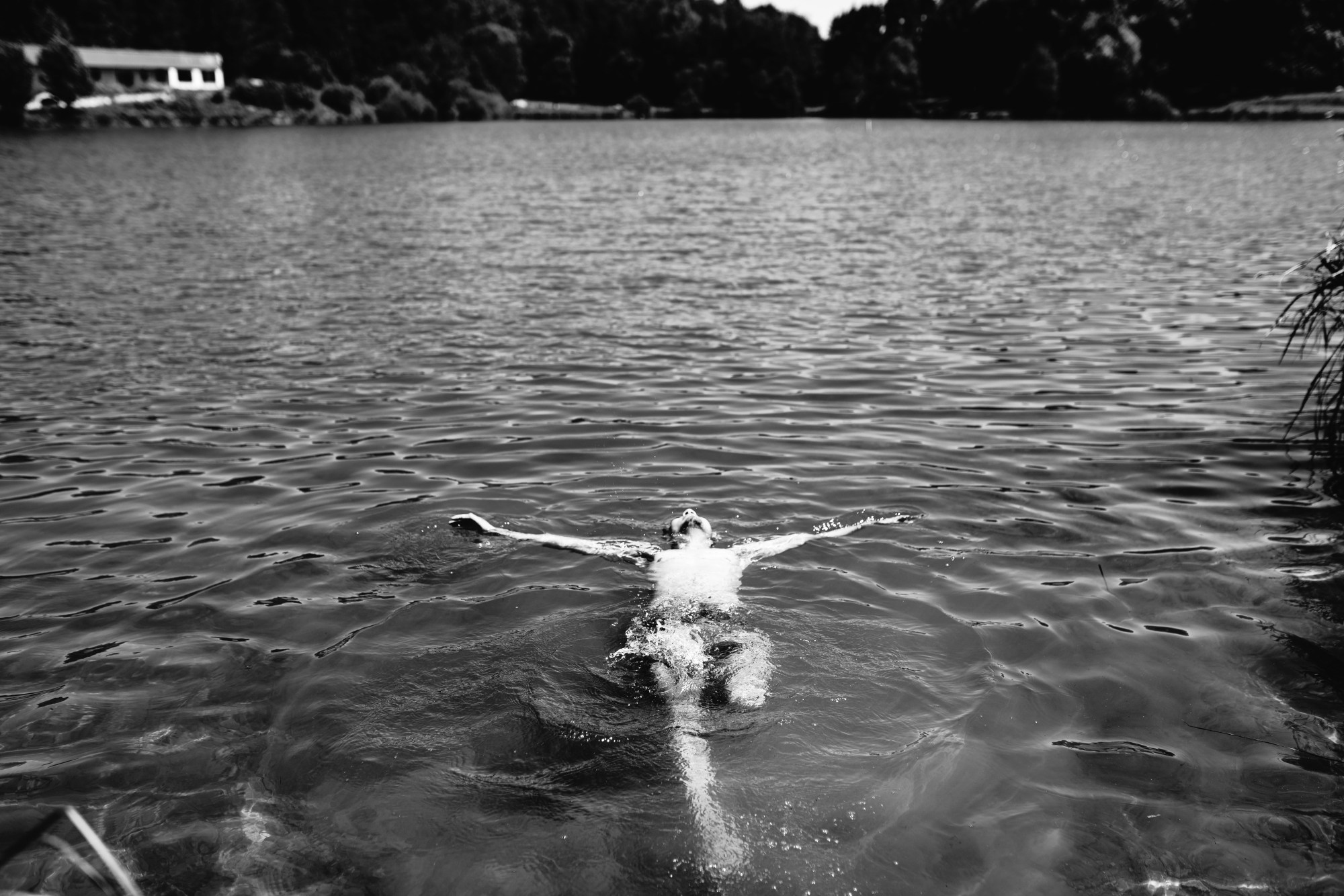 a person spread out and floating in a lake