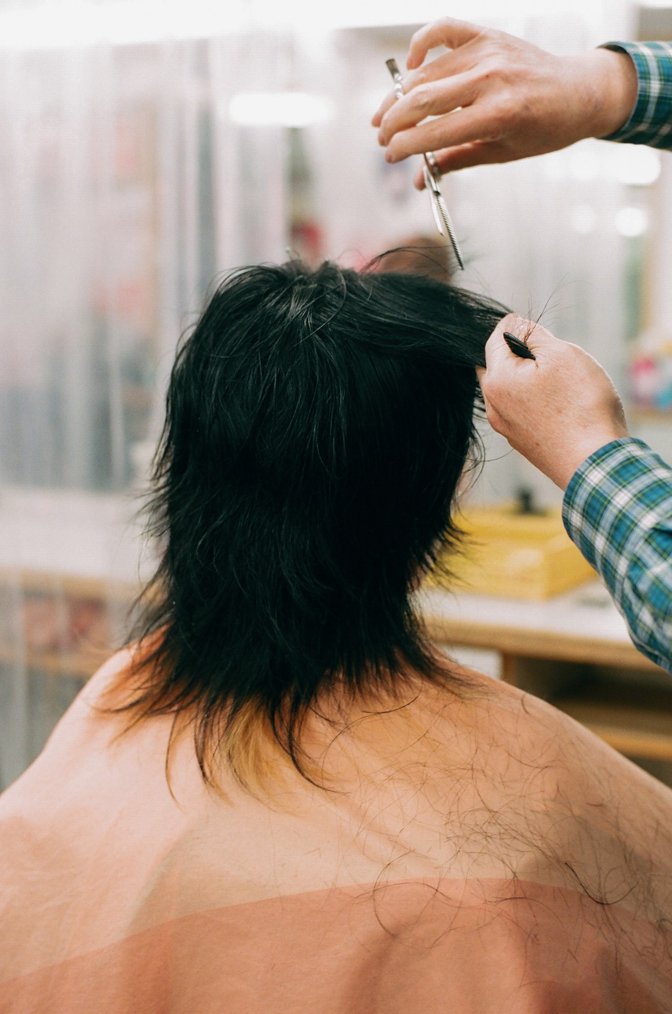 a person getting their hair cut