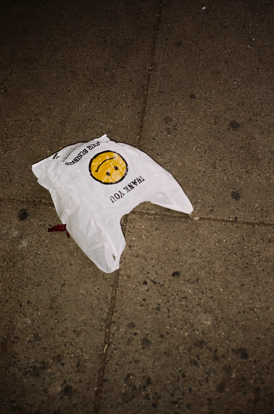 a plastic bag with a smiley face on the floor