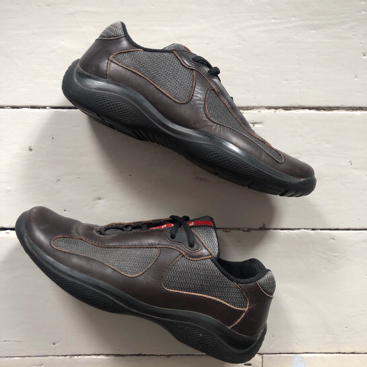 A pair of Brown Prada Linea Rossa shoes