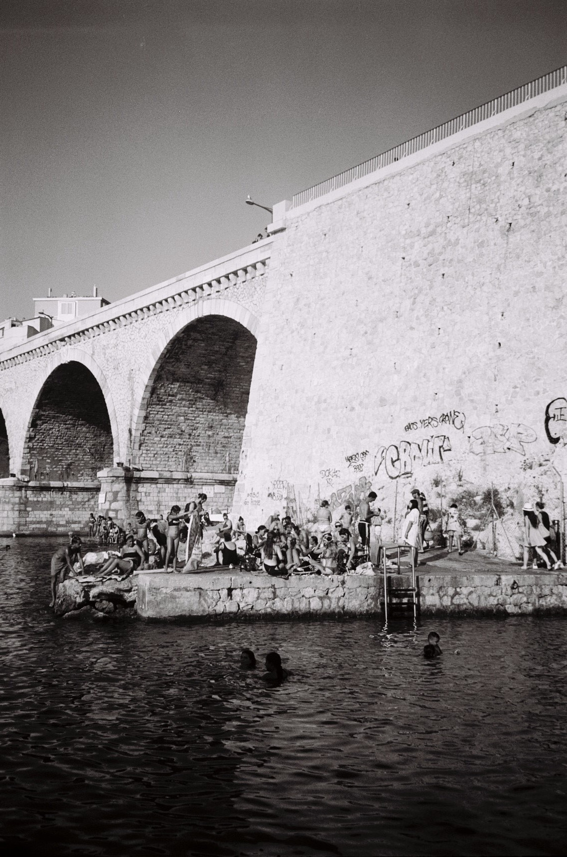 a big group of people under a bridge