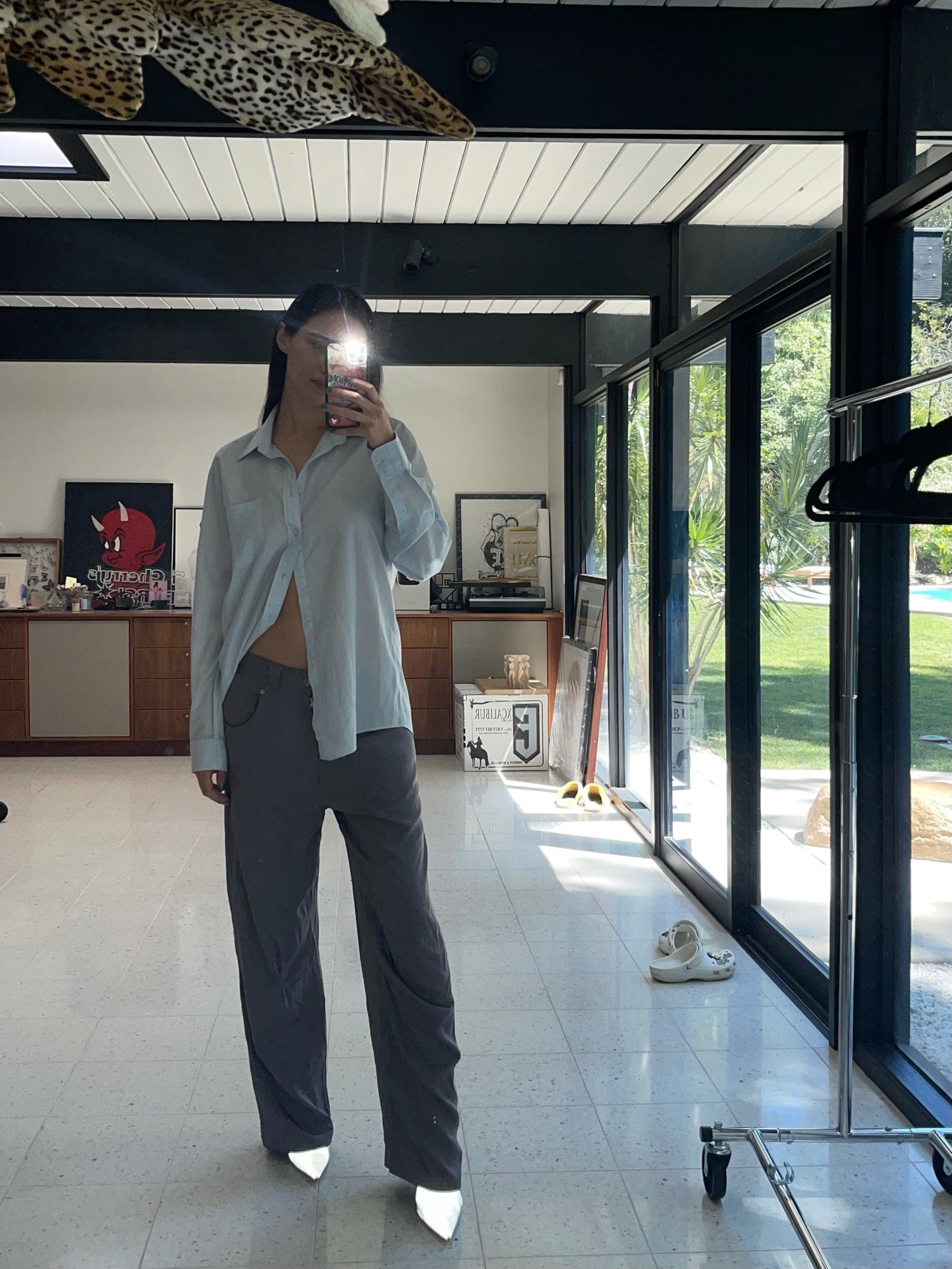 devon lee carlson posing for a selfie in a button up and oversize pants