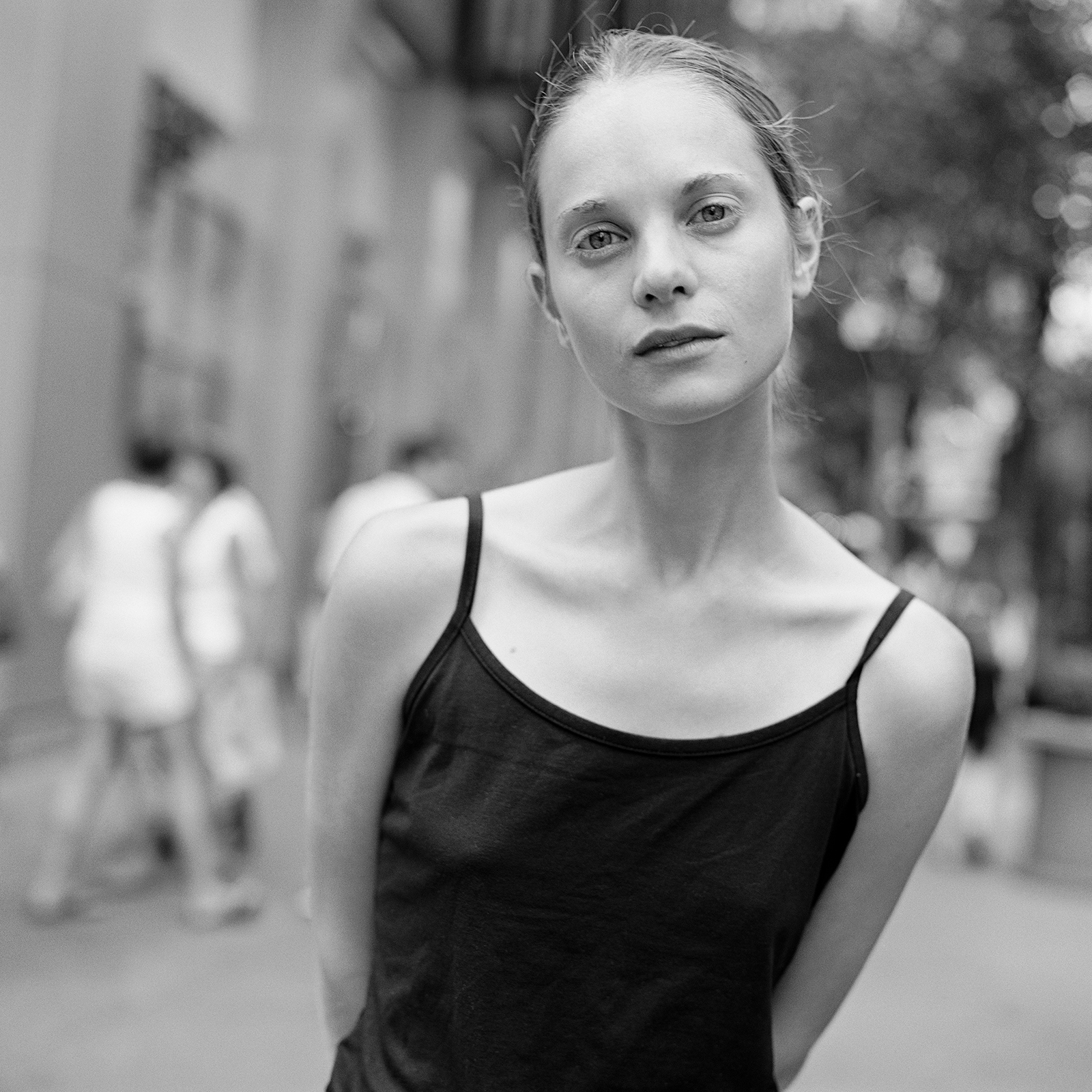 a woman in a black tank top on the street