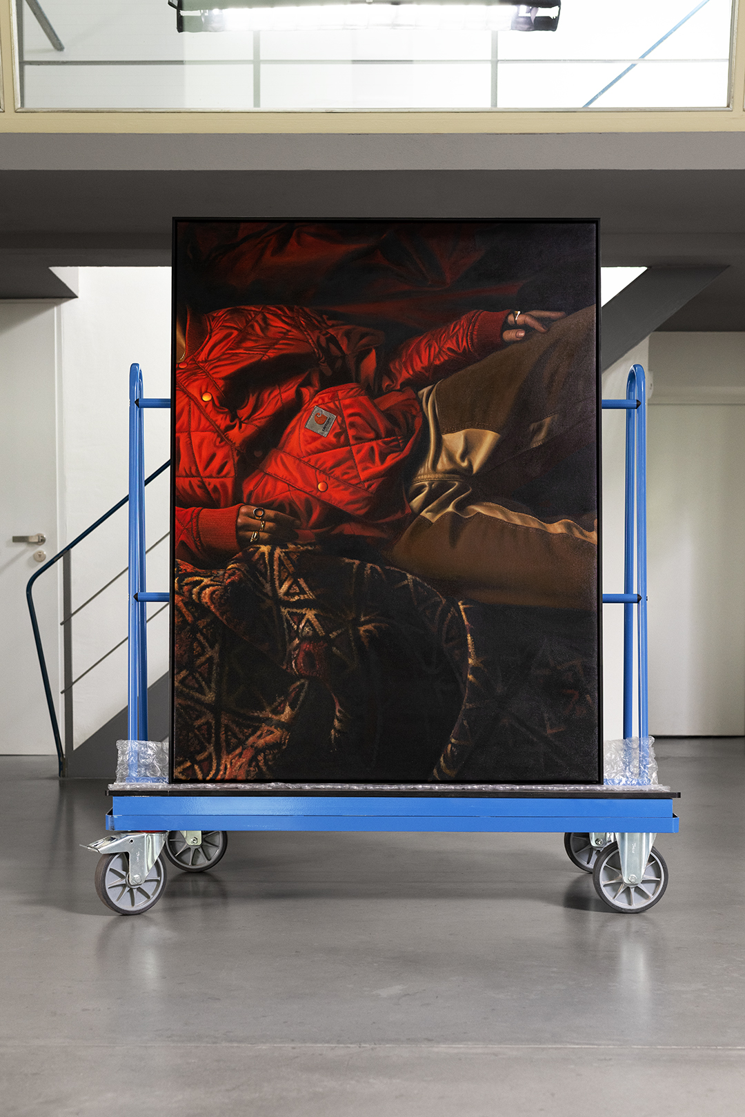 Carhartt WIP red jacket painting on a trolley by Lucas Price