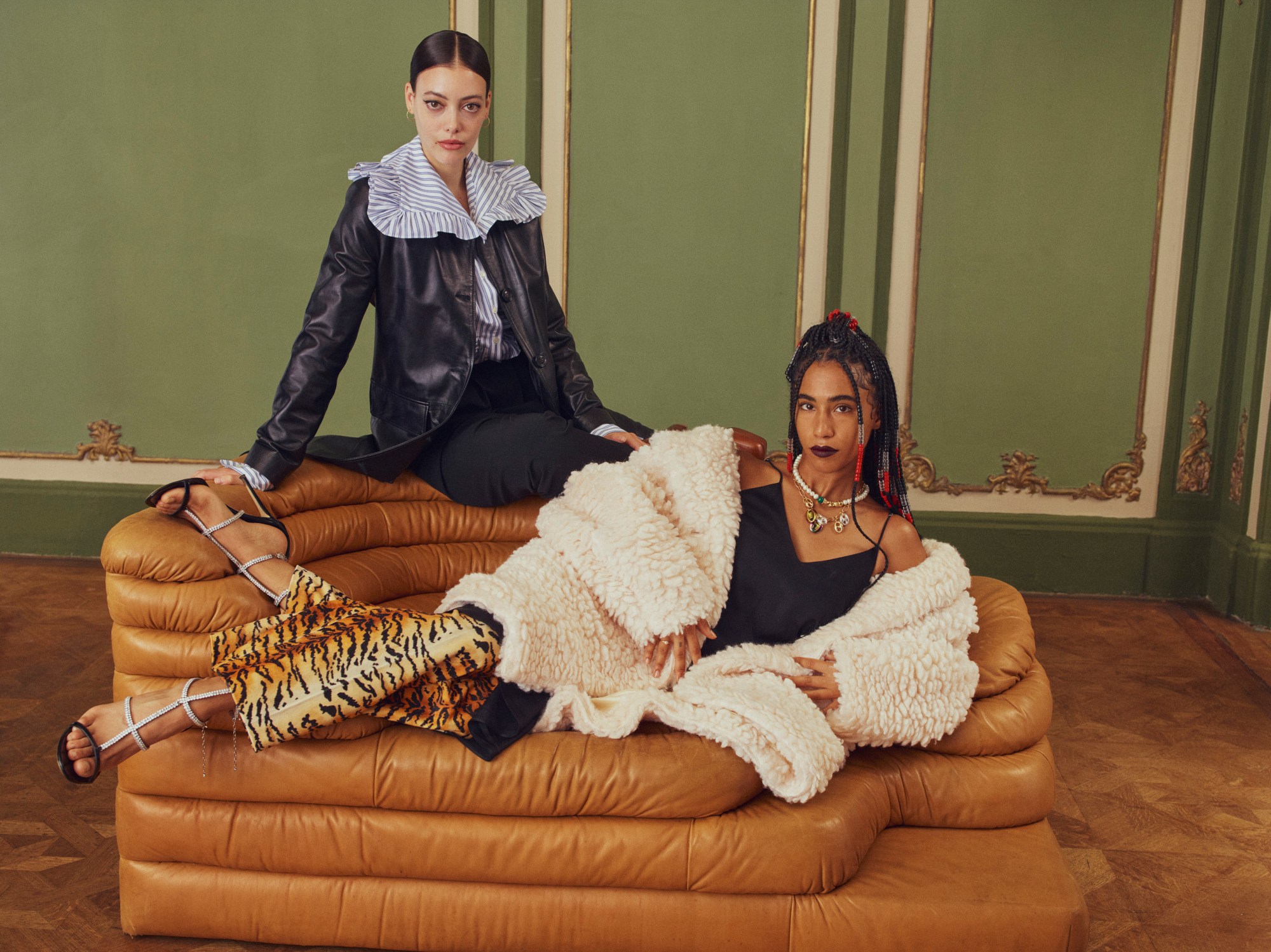 models on a sofa in an vintage-style room by coco capitan