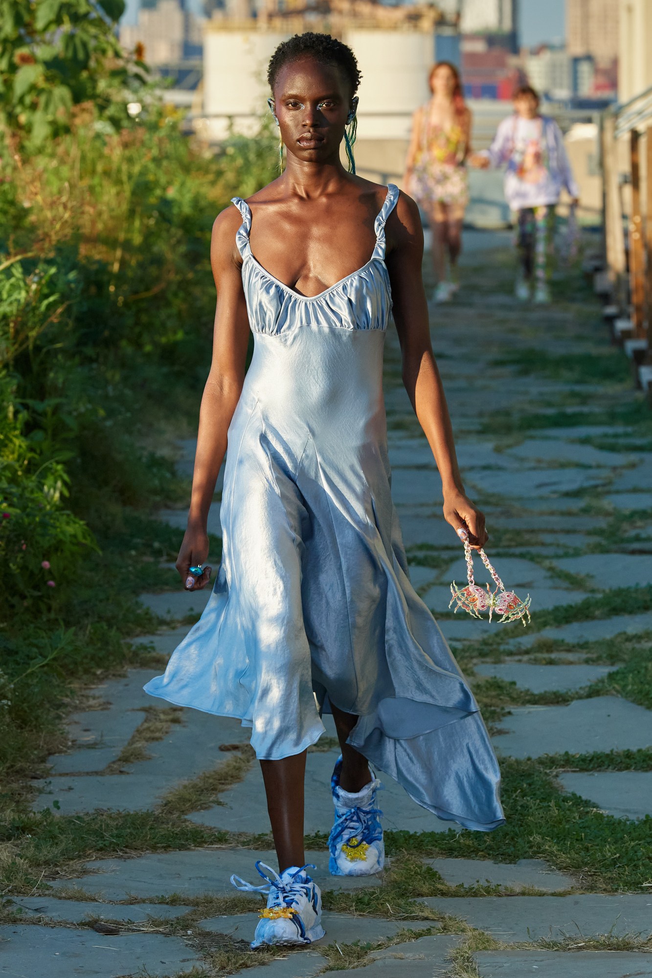 model walking down the runway outside wearing collina strada ss22