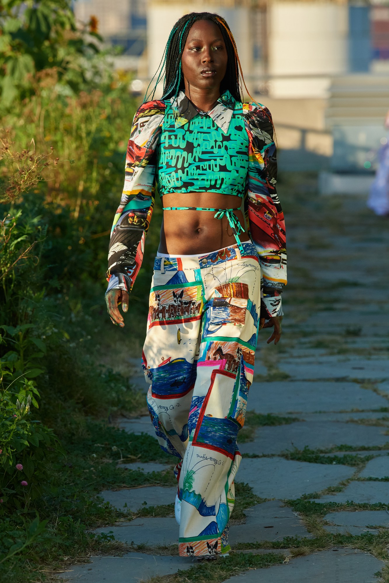 model walking down the runway outside wearing collina strada ss22