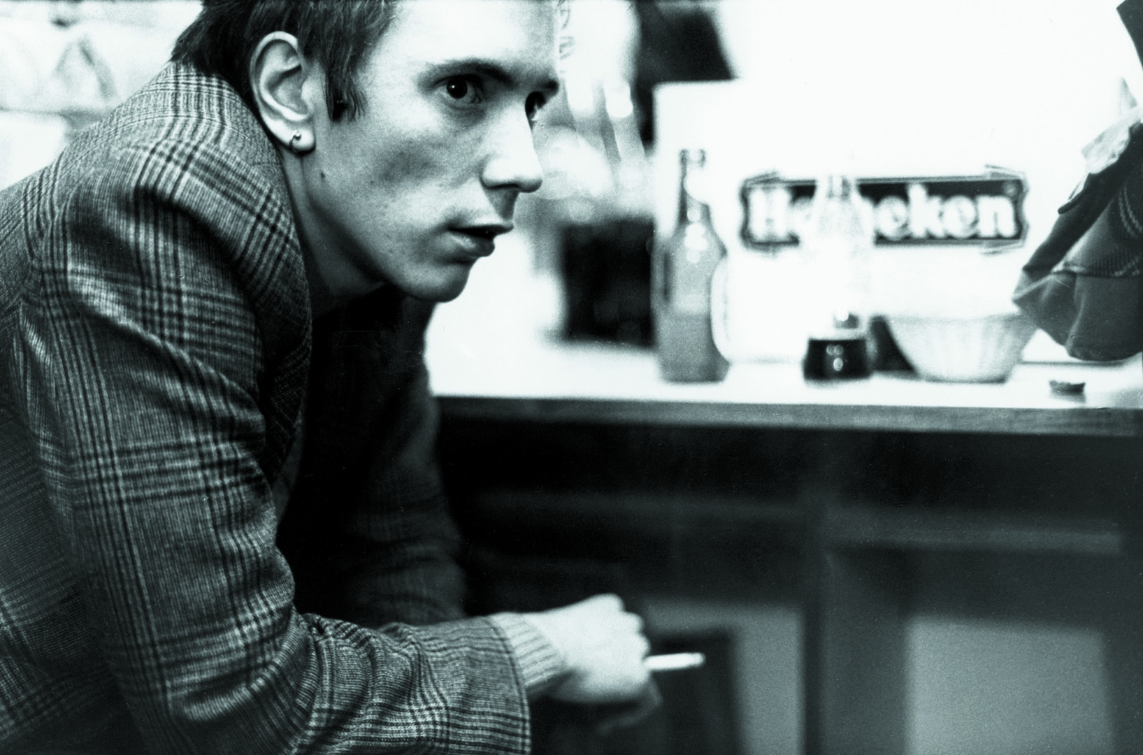 a portrait of johnny rotten in a restaurant by pierre rene-worms