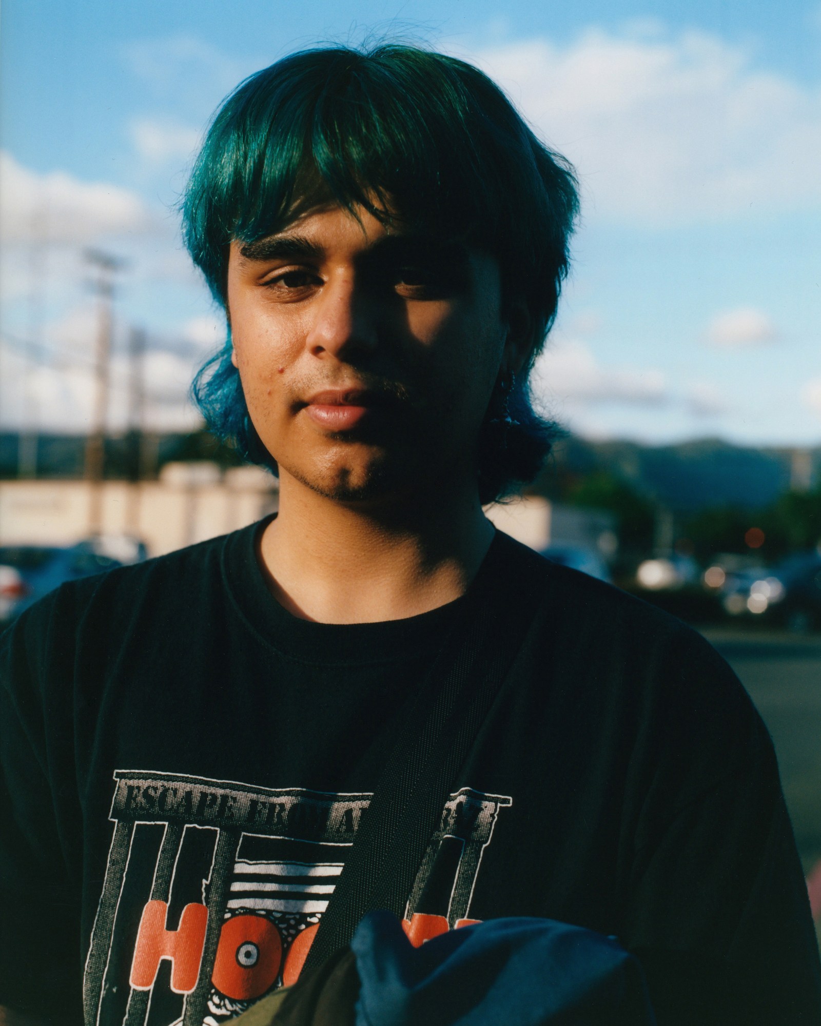 a young man with dyed blue hair