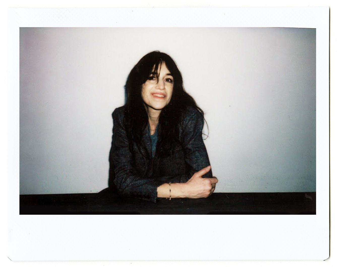 a polaroid portrait of charlotte gainsbourg with her arms crossed by hugo huerta marin