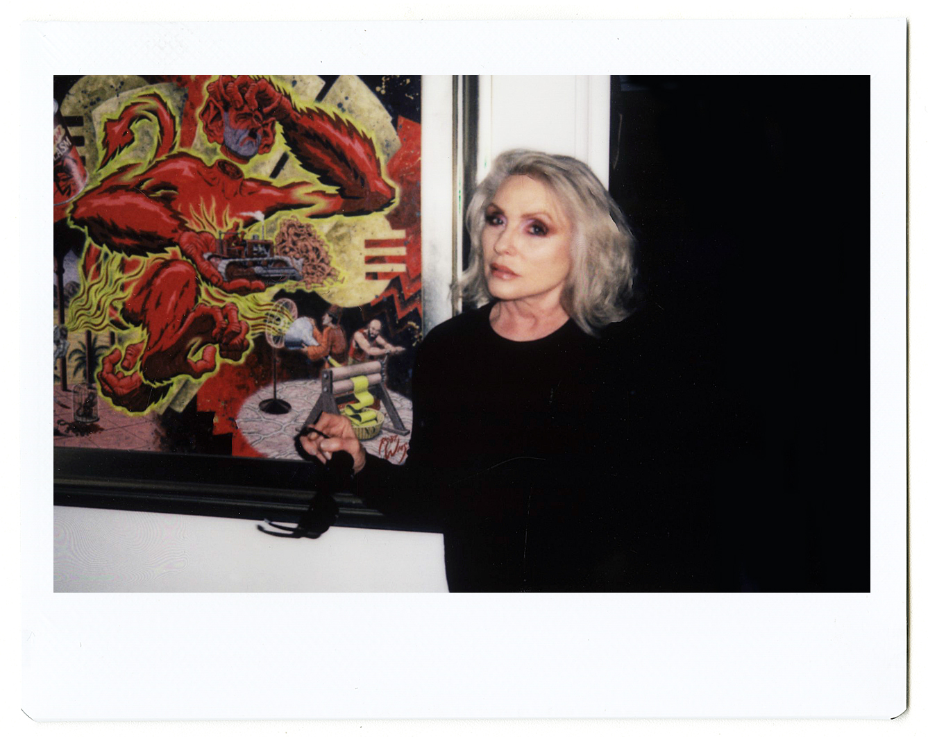 a polaroid portrait of debbie harry in front of art by hugo huerta marin