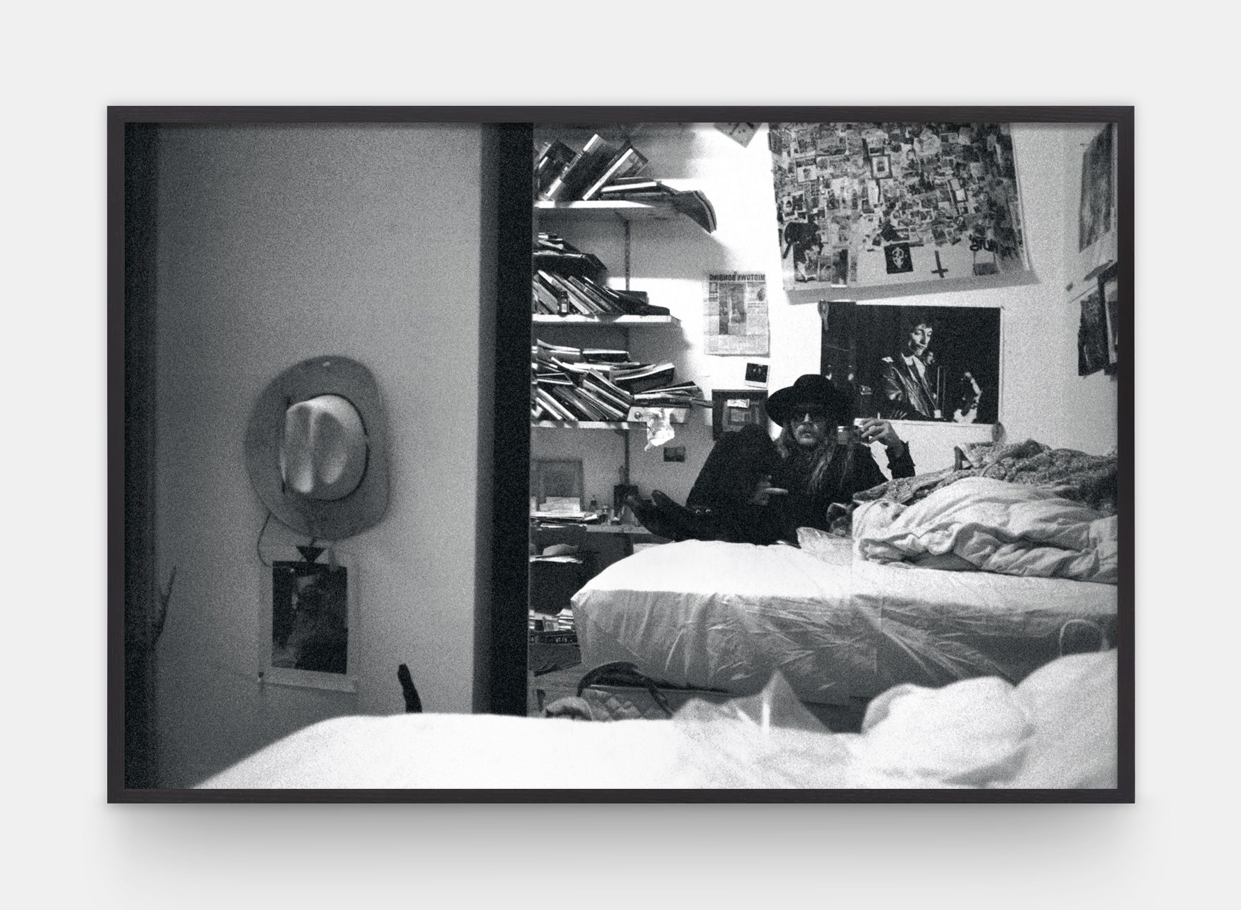 a self-portrait in a mirror of artist dash snow lying on a bed