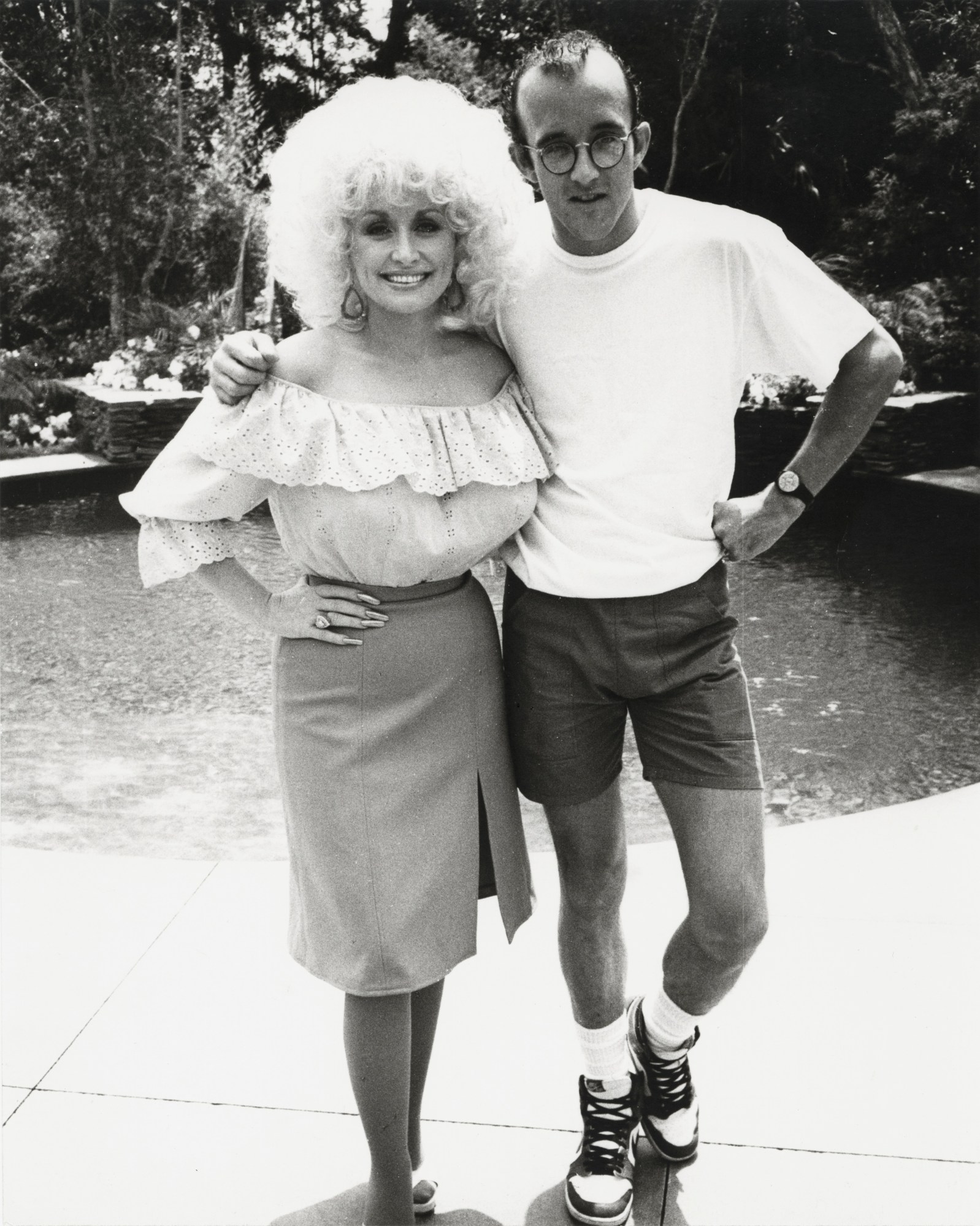 a portrait of dolly parton and keith haring standing outside by andy warhol