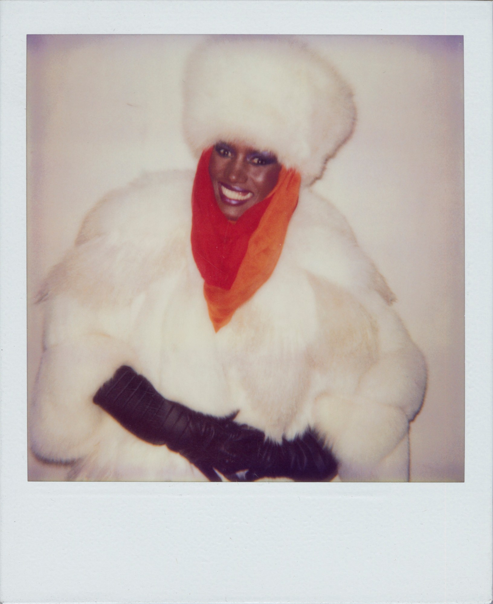 a polaroid of grace jones in a fur coat and hat by andy warhol