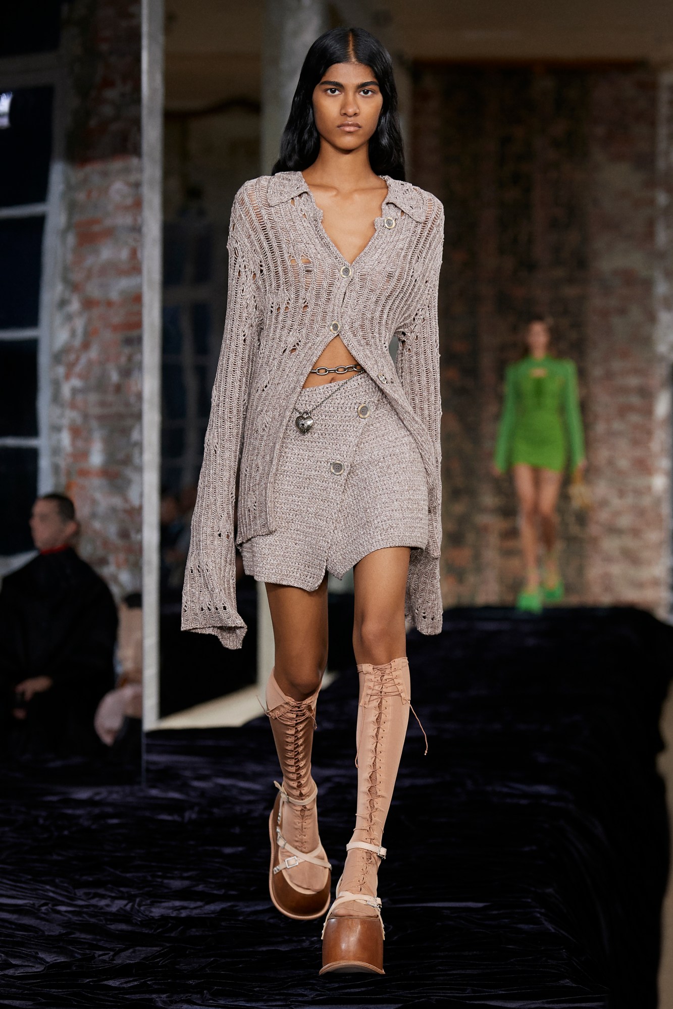 Acne Studios SS22: a model wears a beige knit twin set and chunky nude heels