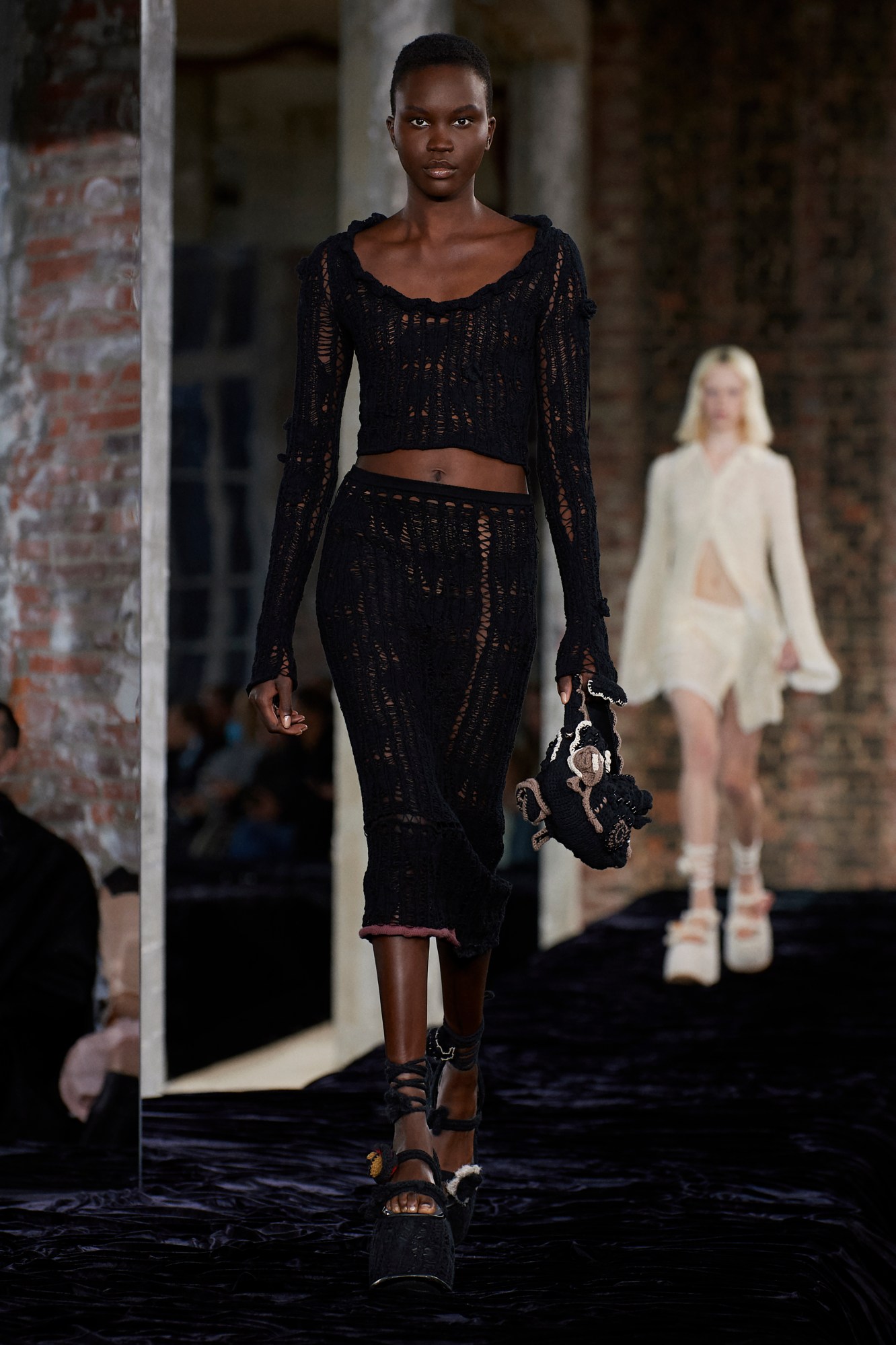 Acne Studios SS22: a model wears a crochet midi skirt and matching crop top