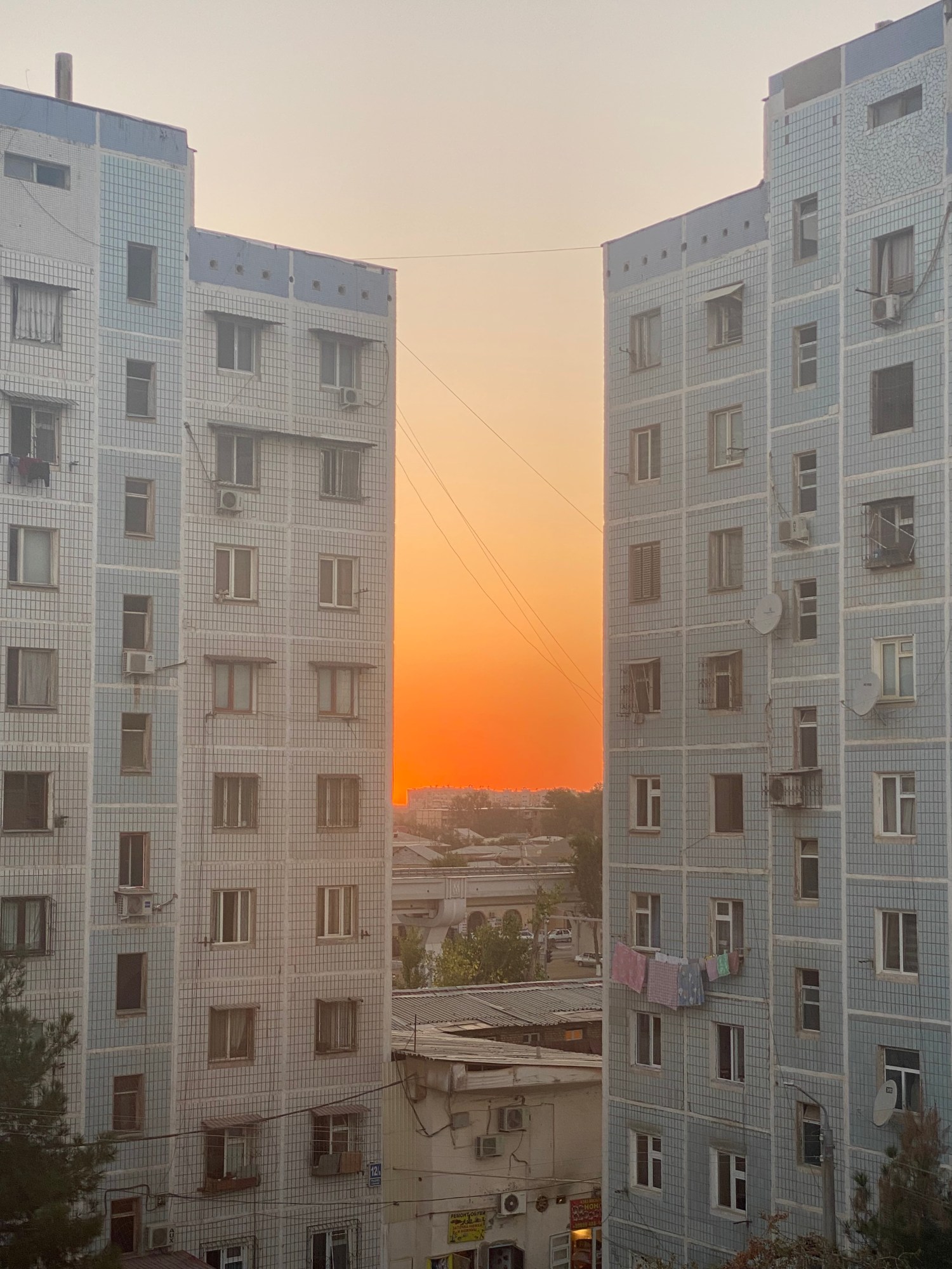 The sunset between old buildings