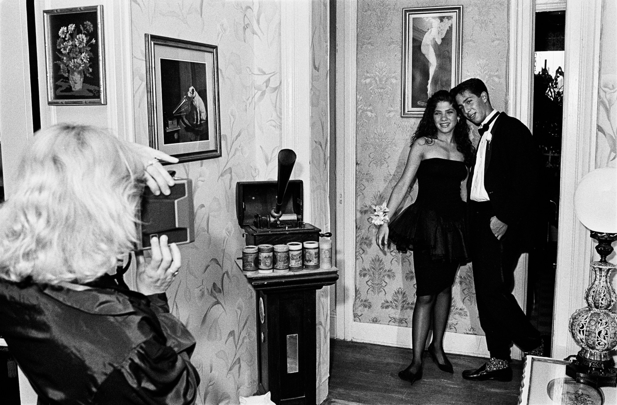 a young woman and man pose for a picture in formal prom clothing