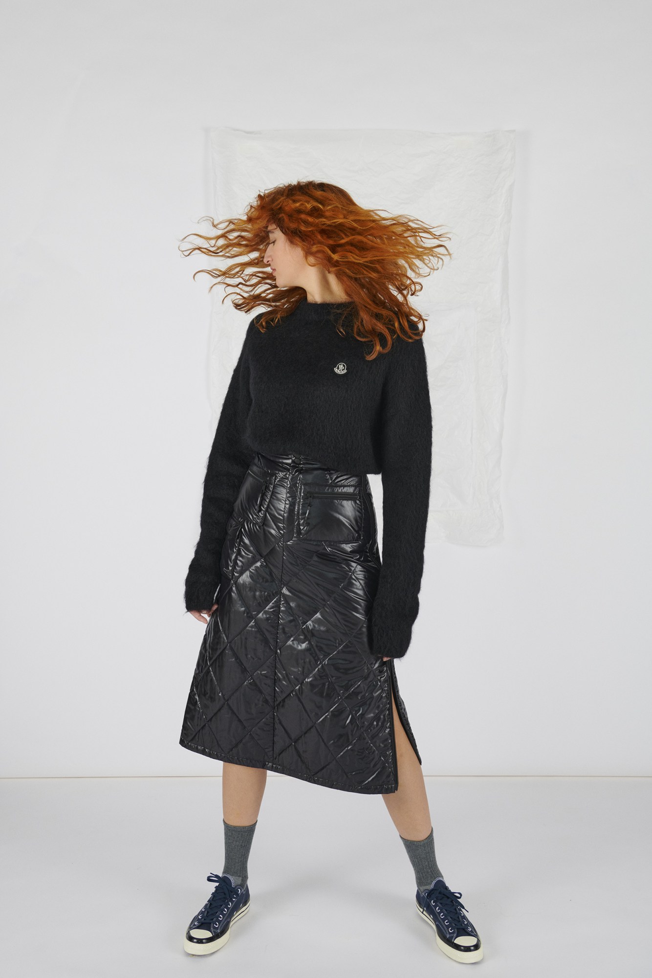 Model wears quilted skirt, jumper and trainers by 7 Moncler Frgmt Hiroshi Fujiwara