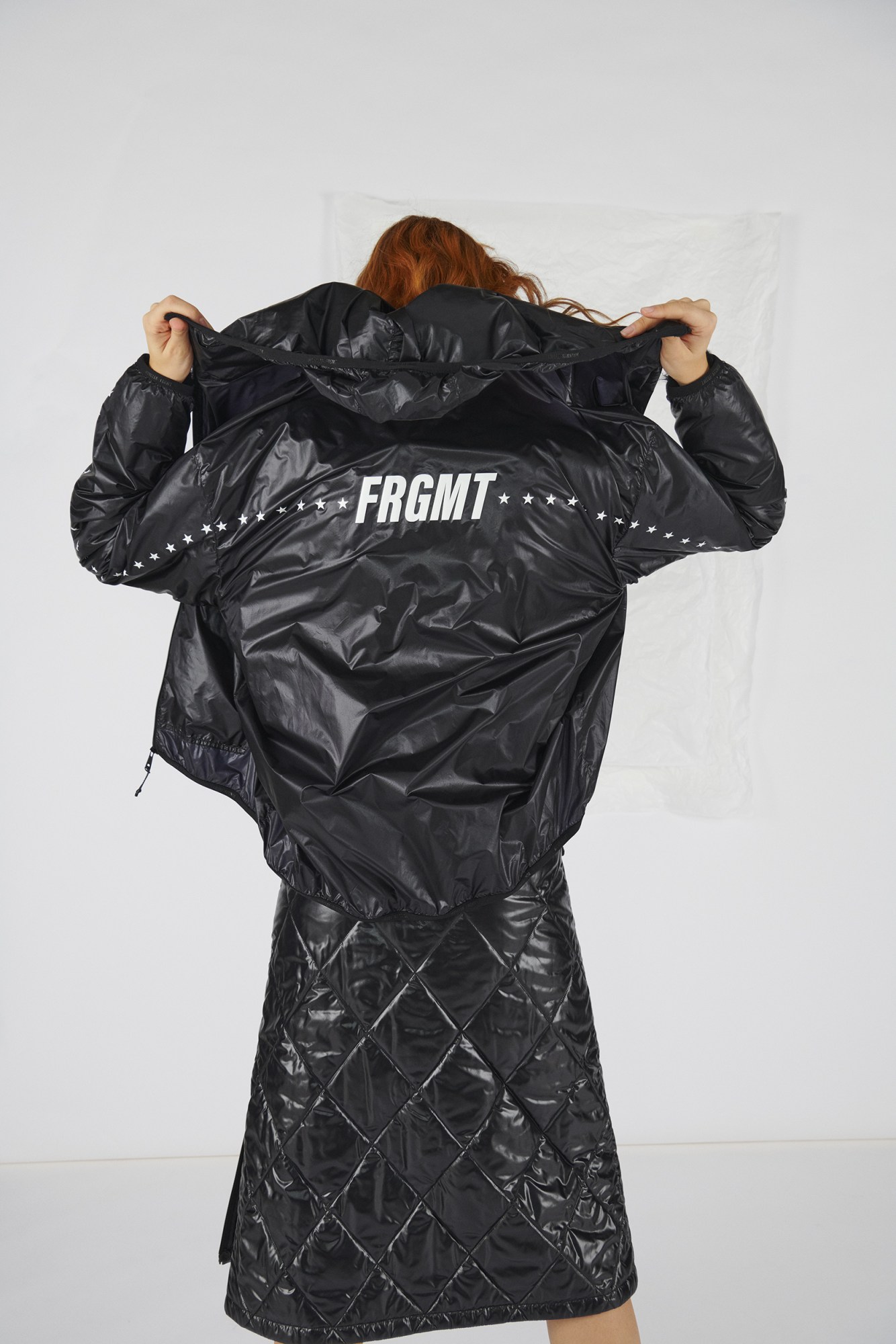 Model wears quilted skirt and coat by 7 Moncler Frgmt Hiroshi Fujiwara