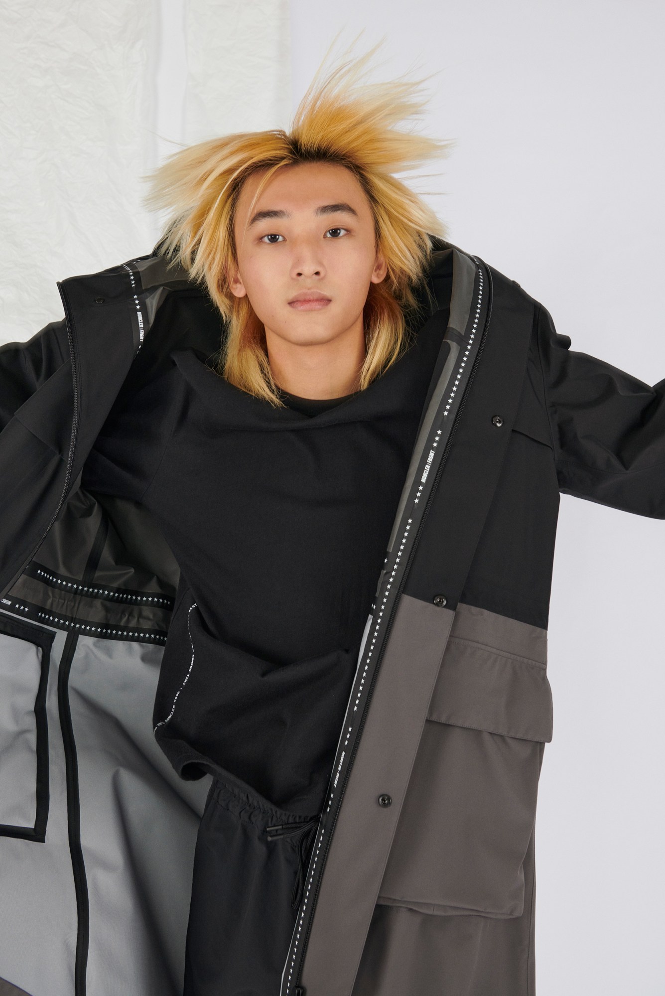 Model wears trousers, top and coat by 7 Moncler Frgmt Hiroshi Fujiwara