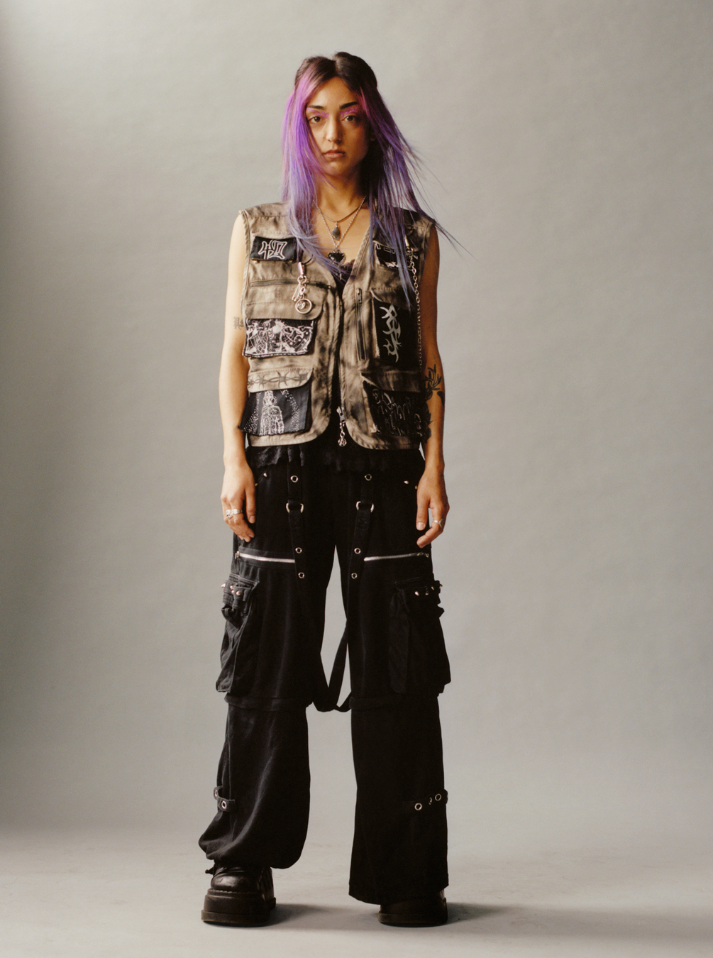 a Lola + Pani photograph of a model with violet hair wearing baggy skate trousers and a utility jacket