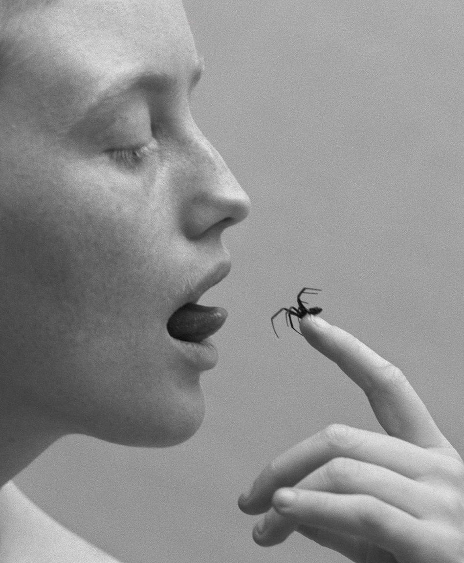 a close up photo of bobbi salvor menuez eating a spider by michael bailey-gates