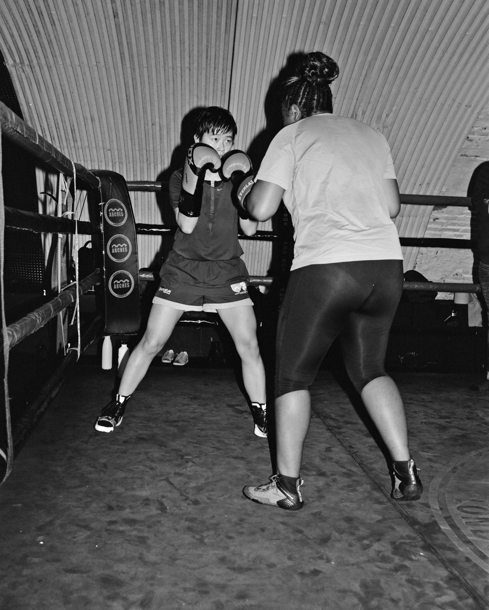 two people boxing in a ring