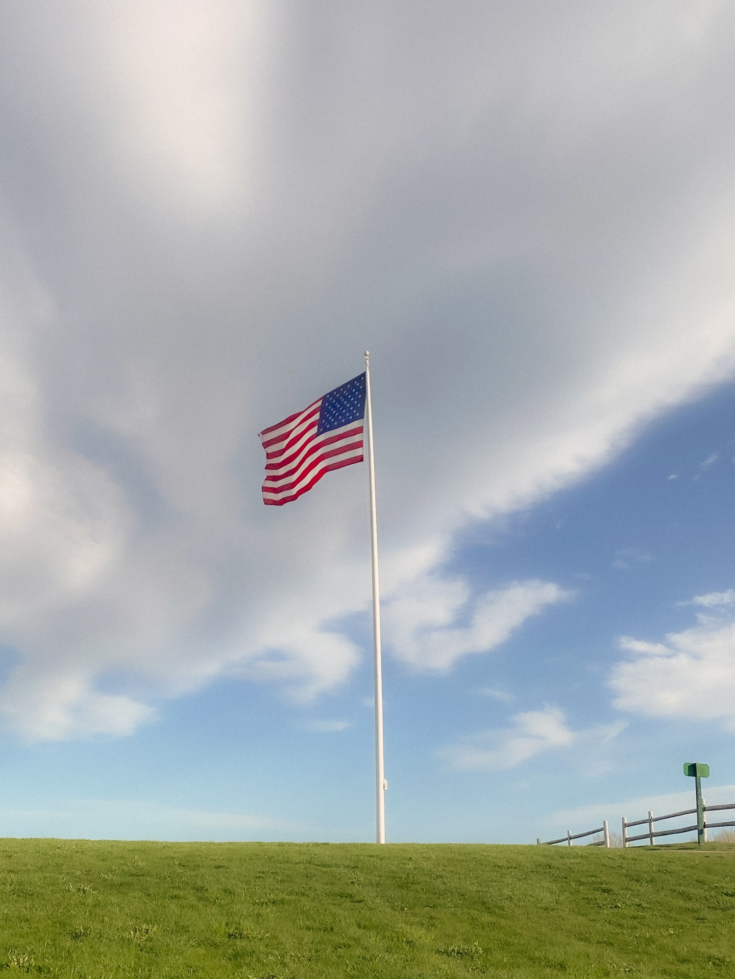 the american flag in the middle of a field.