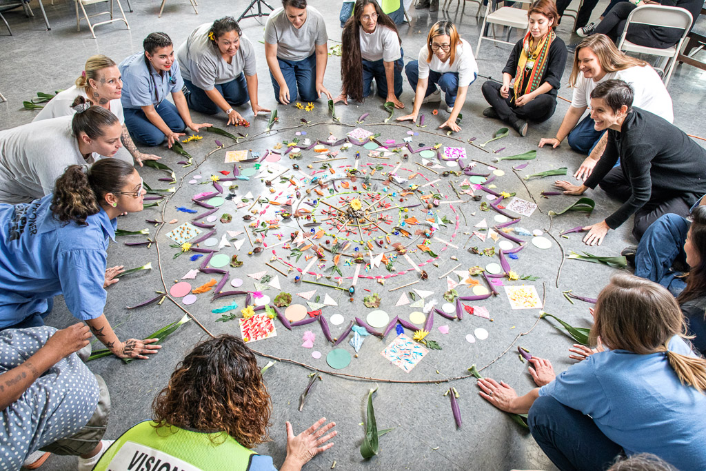 prison inmates and their teachers making a mandala