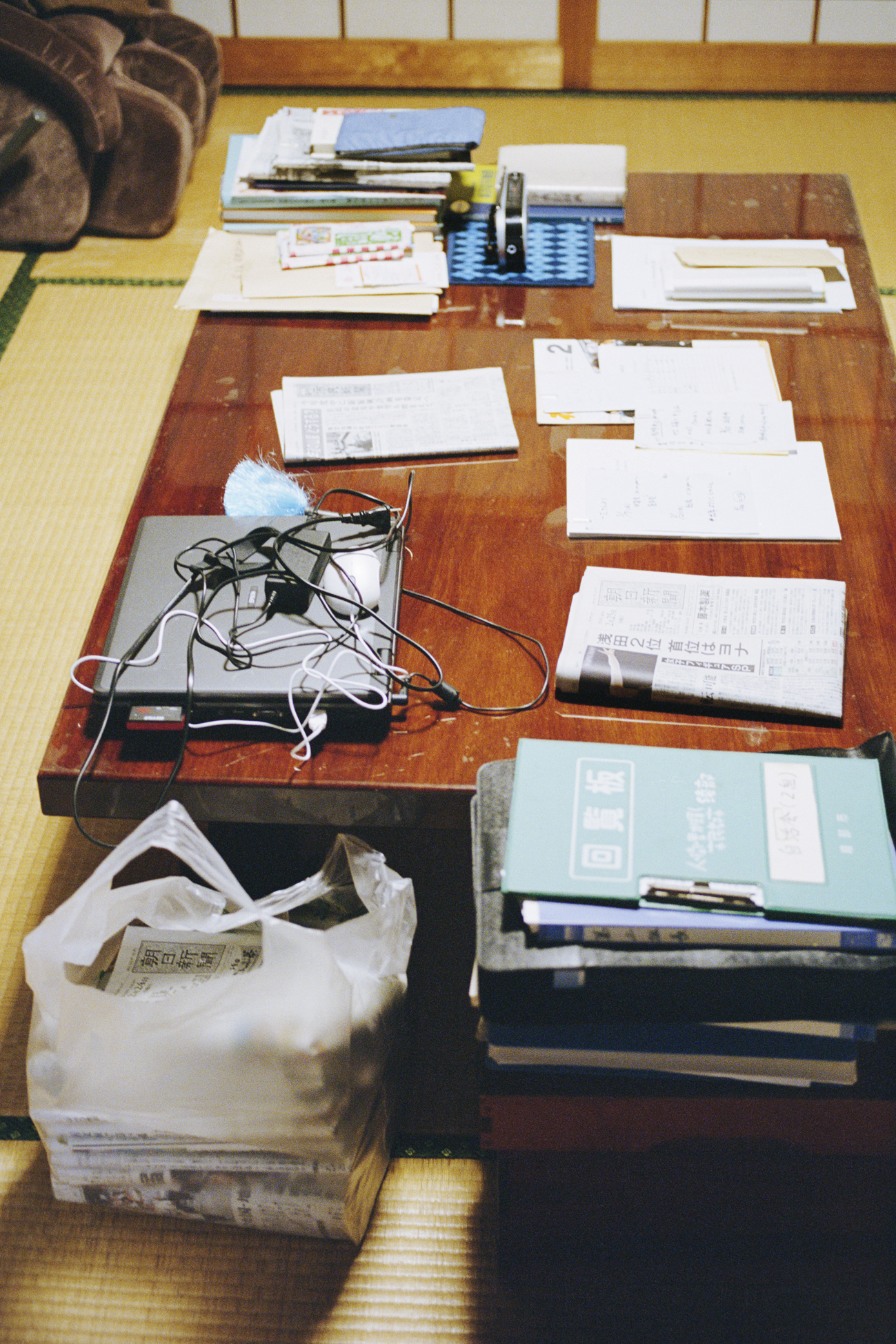 a desk with papers and a laptop on it