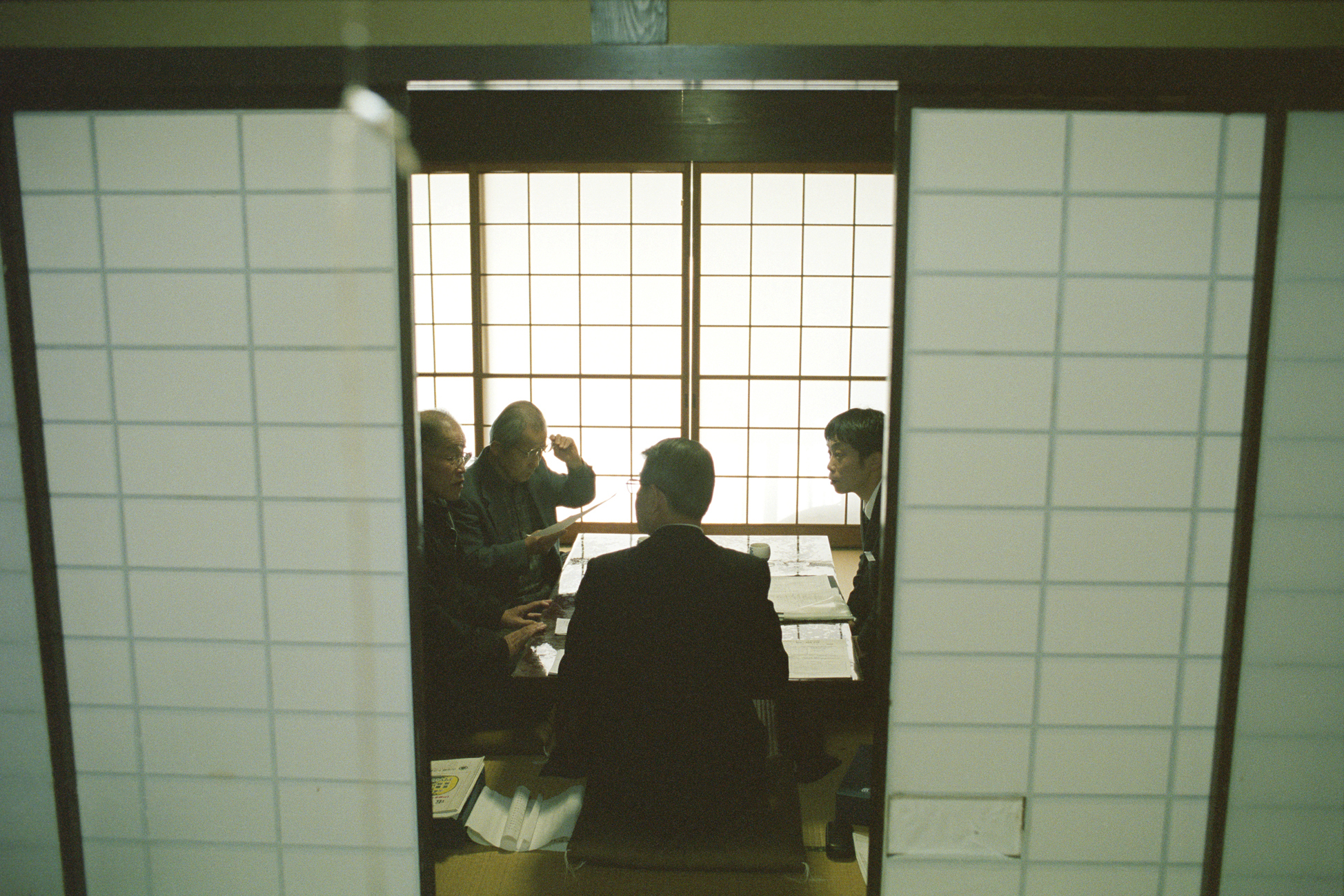 men in suits sat around a table