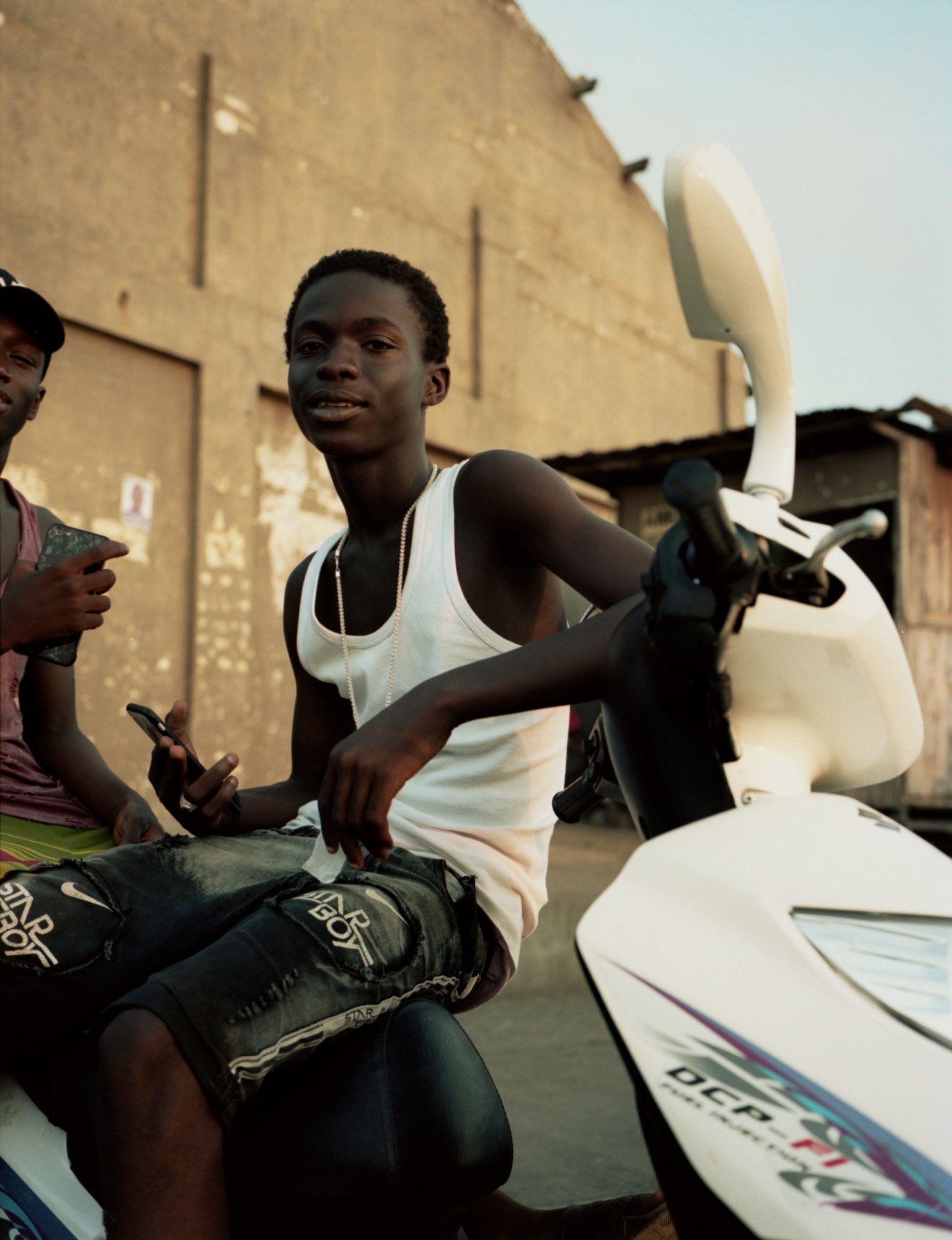 a young boy posing on a bike in ghana