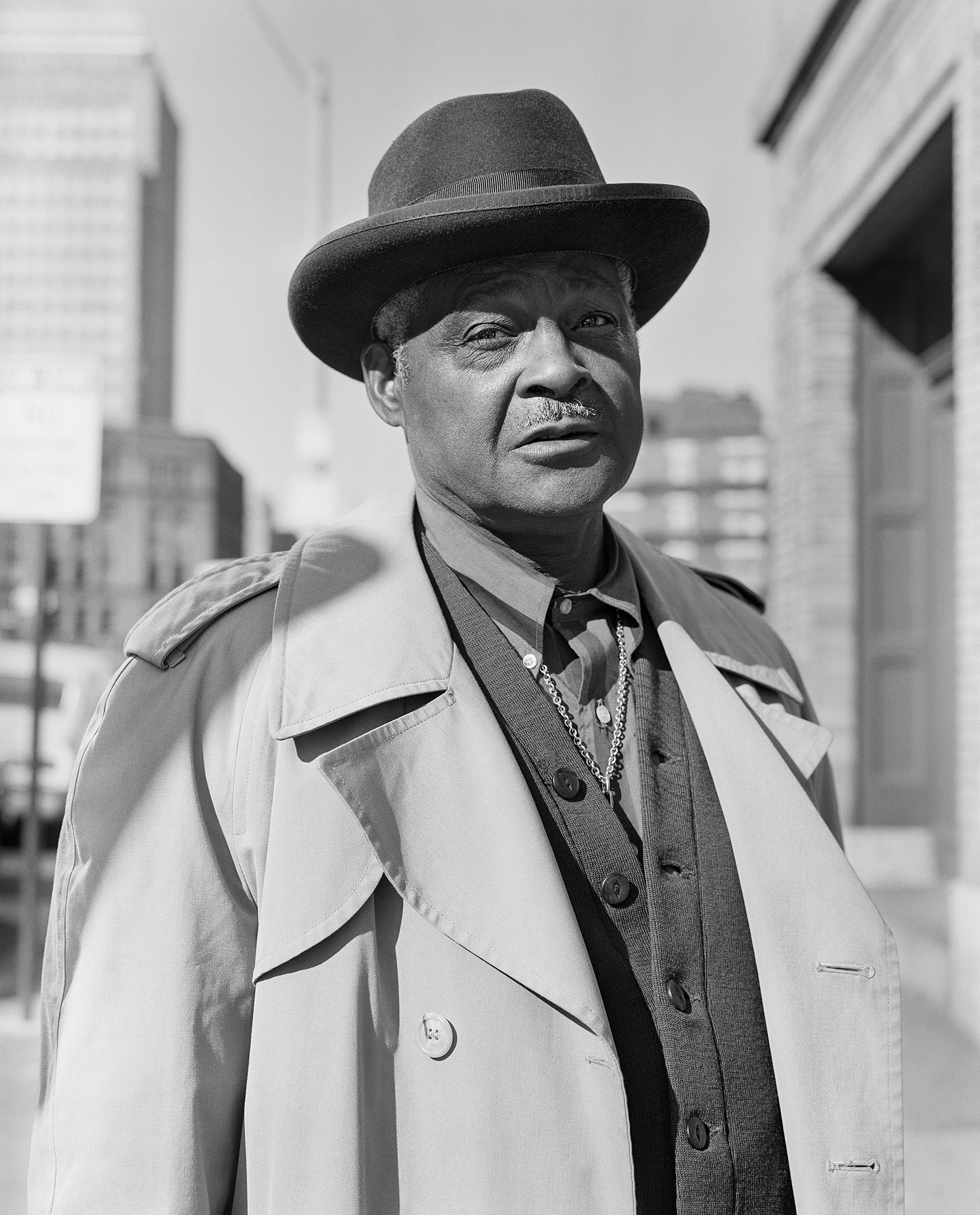 an older man in a hat and large overcoat