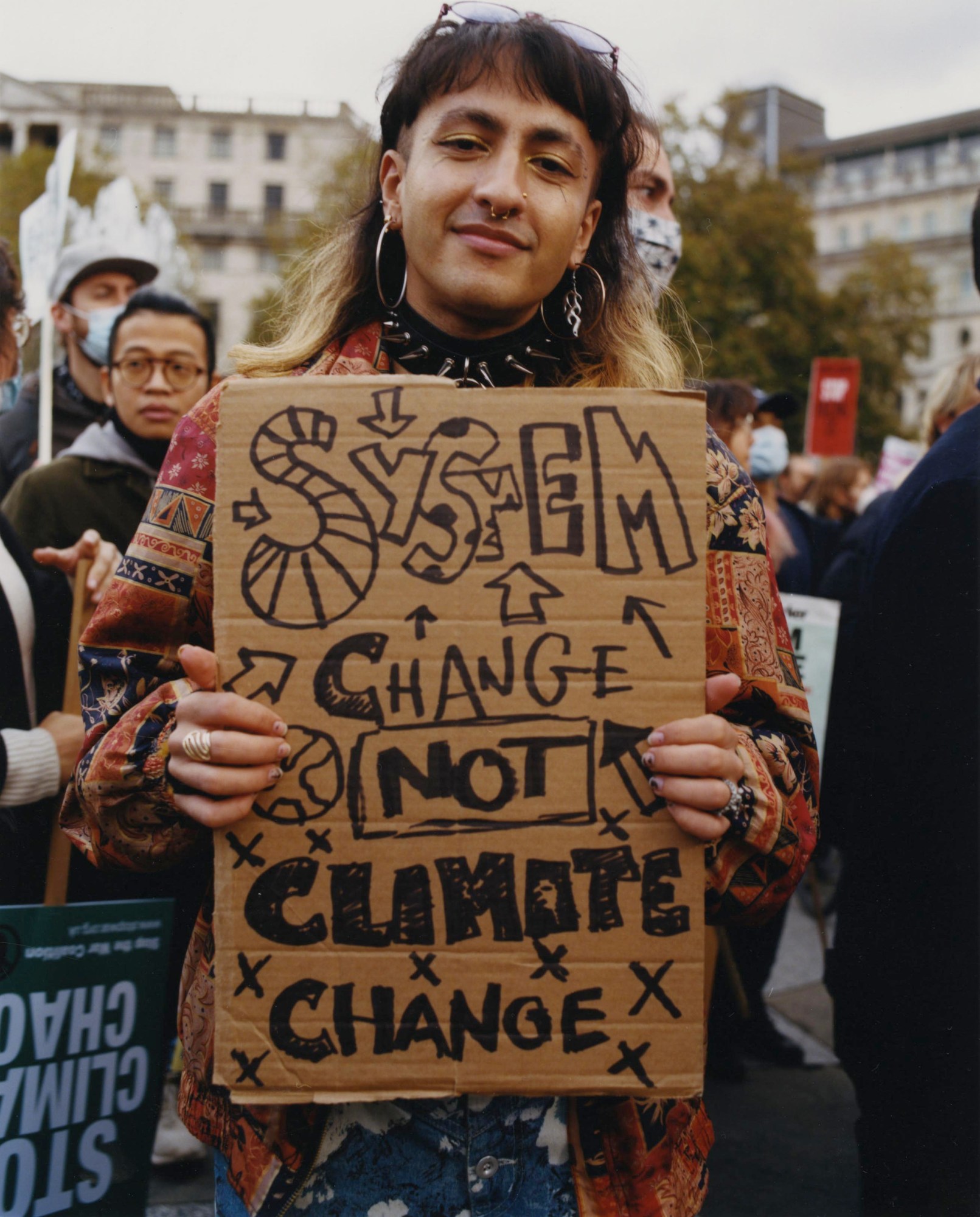 an activist holding a sign about climate change while protesting cop26 by heather glazzard