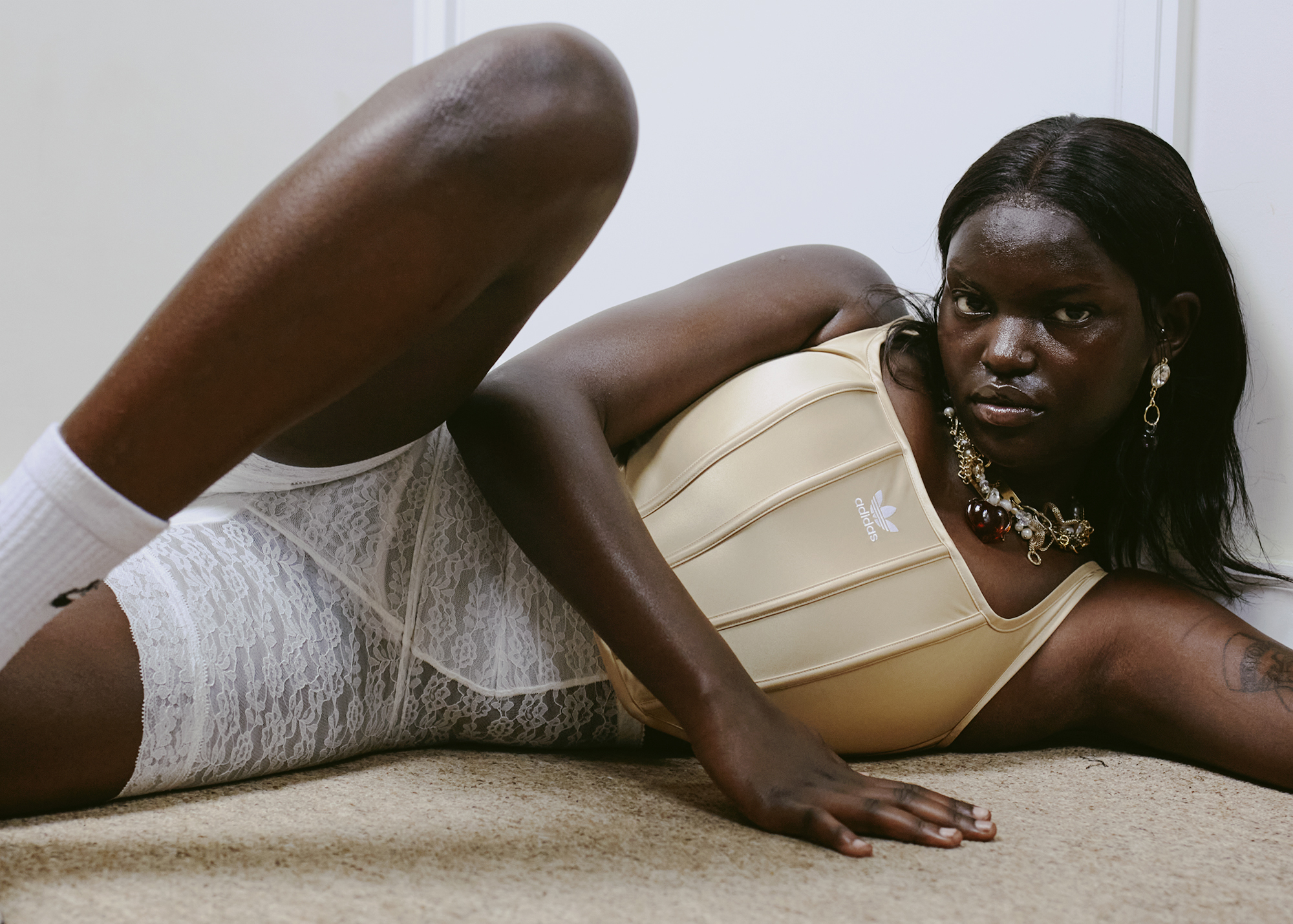 a young woman poses on the floor