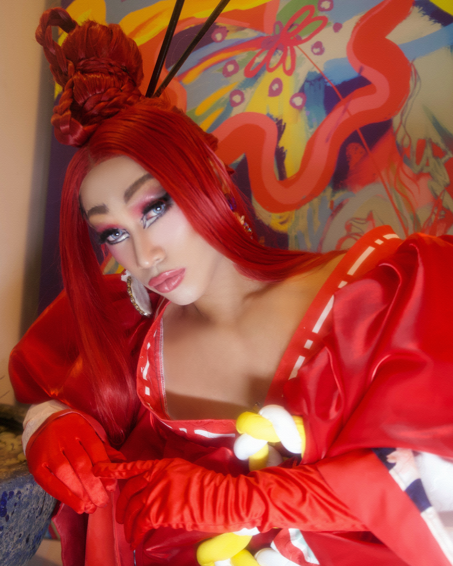 portrait of vietnamese drag queen choo choo in an all red outfit