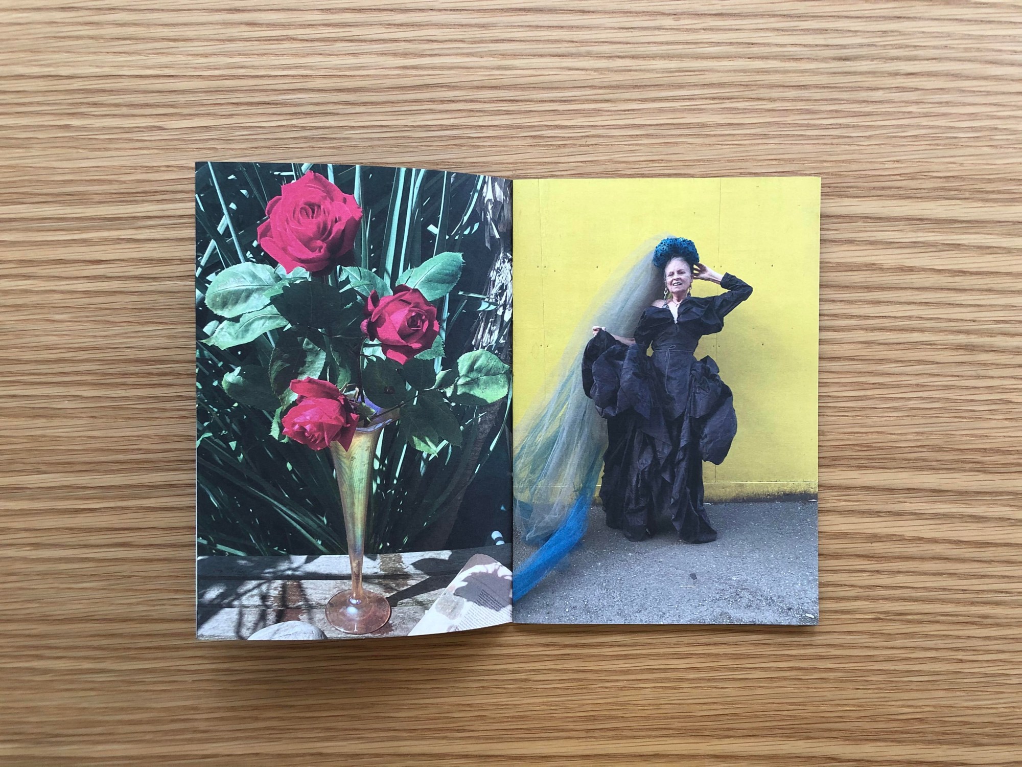 a spread from the vivienne westwood zine: 3 red roses in a glass vase on the left, westwood herself in a black gown and blue veil on the right