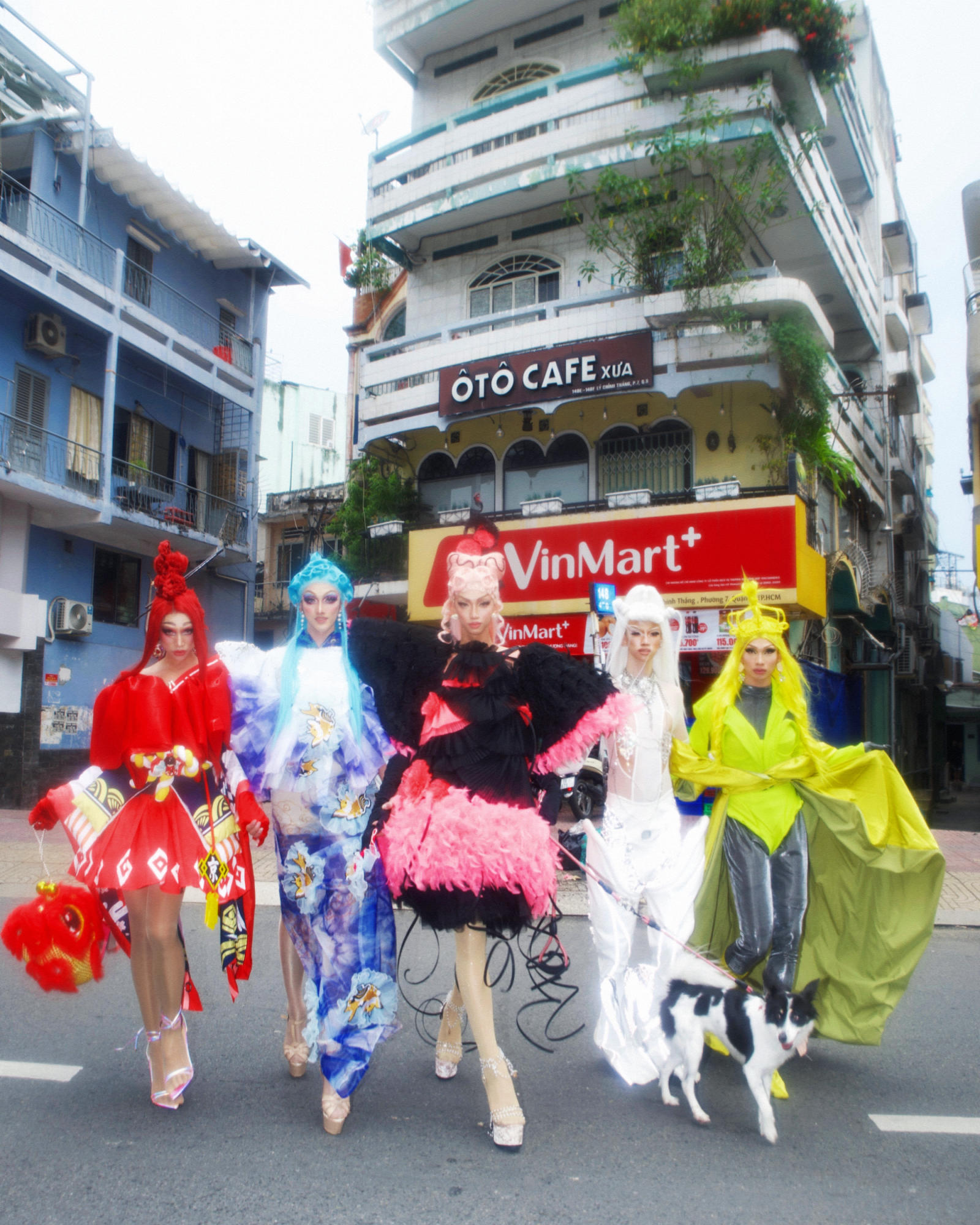 five drag queens crossing the street in front of a shop in ho chi minh city